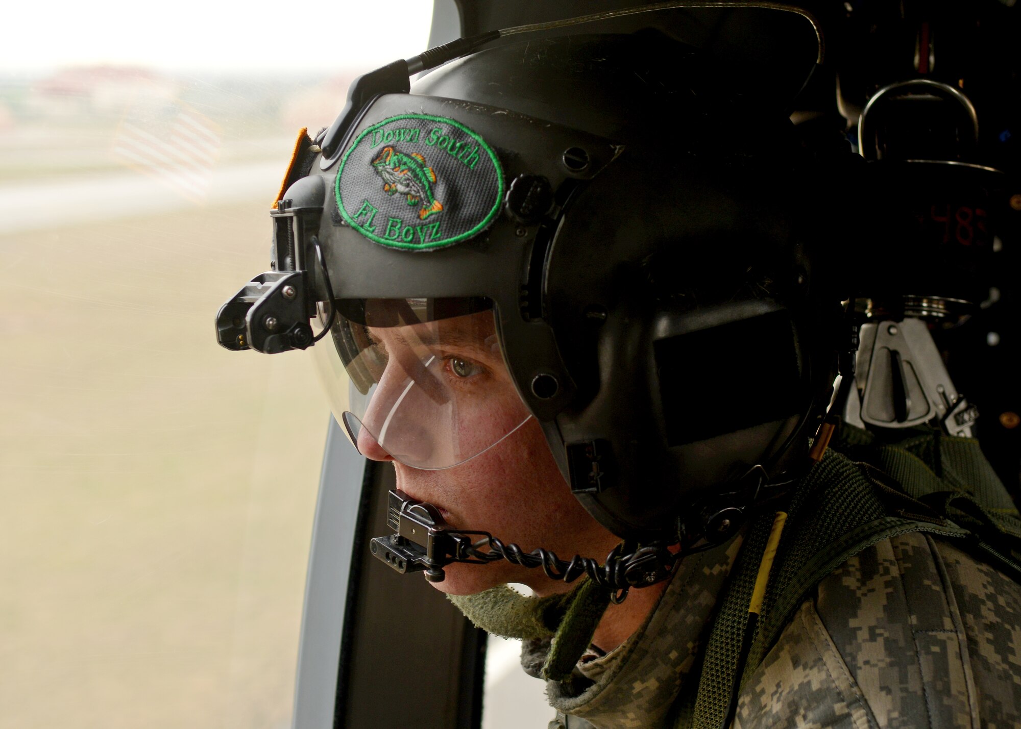 U.S. Army Sgt. Keith Dishman, 12th Combat Aviation Brigade crew chief, looks out the window of a UH-60 Black Hawk helicopter during a joint-service combat search and rescue training mission, Jan. 28, 2014, at Cellina Meduna, Italy. There were several aspects to the training mission to include close air support, Survival, Evasion, Resistance and Escape training for personnel on the ground and a search and rescue coordinated with a U.S. Army UH-60 Black Hawk helicopter crew extracting isolated pilots from “hostile” environments. (U.S. Air Force/Senior Airman Briana Jones)