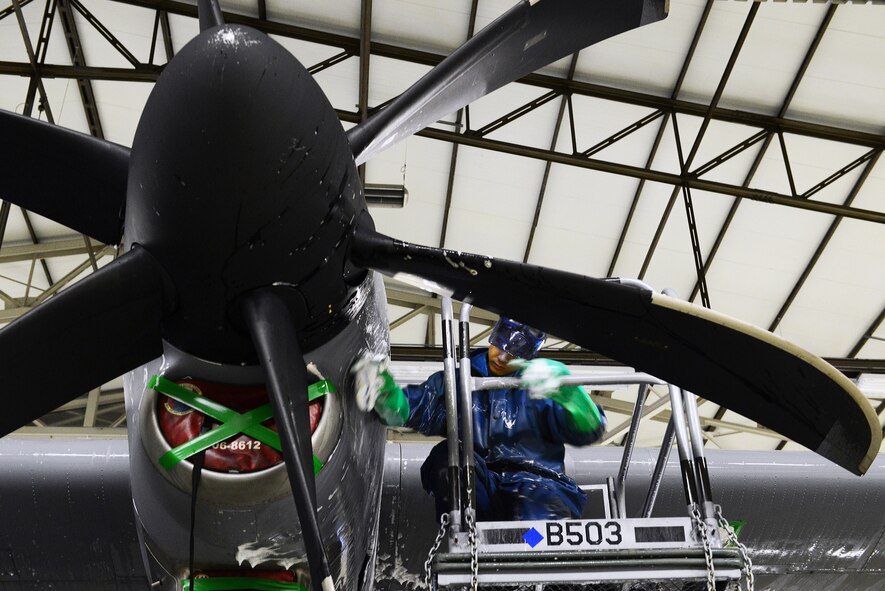 Senior Airman Jonathan Deguzman, 86th Maintenance Squadron aerospace systems technician, scrubs the wing of a C-130J Super Hercules Feb. 10, 2014, Ramstein Air Base, Germany. Airman of the 86th MXS and the 86 Aircraft Maintenance Squadron work daily to keep the aircraft mobile and in working condition. (U.S. Air Force photo/Airman Dymekre Allen)