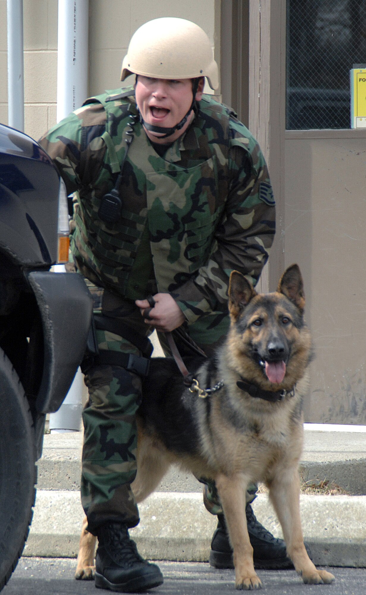 HANSCOM AIR FORCE BASE, Mass. – In this file photo from 2007, Staff Sgt. Anthony Caskey and his Military Working Dog Mix, respond on base to an exercise scenario as part of a Base Readiness Exercise. Mix was euthanized Jan. 9 after being diagnosed with terminal cancer. (U.S. Air Force photo by Linda LaBonte Britt)