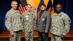 From left, U.S. Army Col. Julius Rigole, 128th Aviation Brigade commander, Sgt. 1st Class Matthew Dine, C Company, 1-210 Avn. Regiment, 128th Avn. Bde. instructor, Jose Garcia, C Co., 1-210 Avn. Regiment, 128th Avn. Bde. instructor, and Command Sgt. Maj. John Moore, 128th Avn. Bde. command sergeant major, pose during the first quarter Instructor of the Quarter ceremony at Fort Eustis, Va., Feb. 7, 2014.  Dine and Garcia were chosen as the Soldier and civilian instructors of the quarter, respectively. (U.S. Air Force photo by Airman 1st Class Austin Harvill/Released)