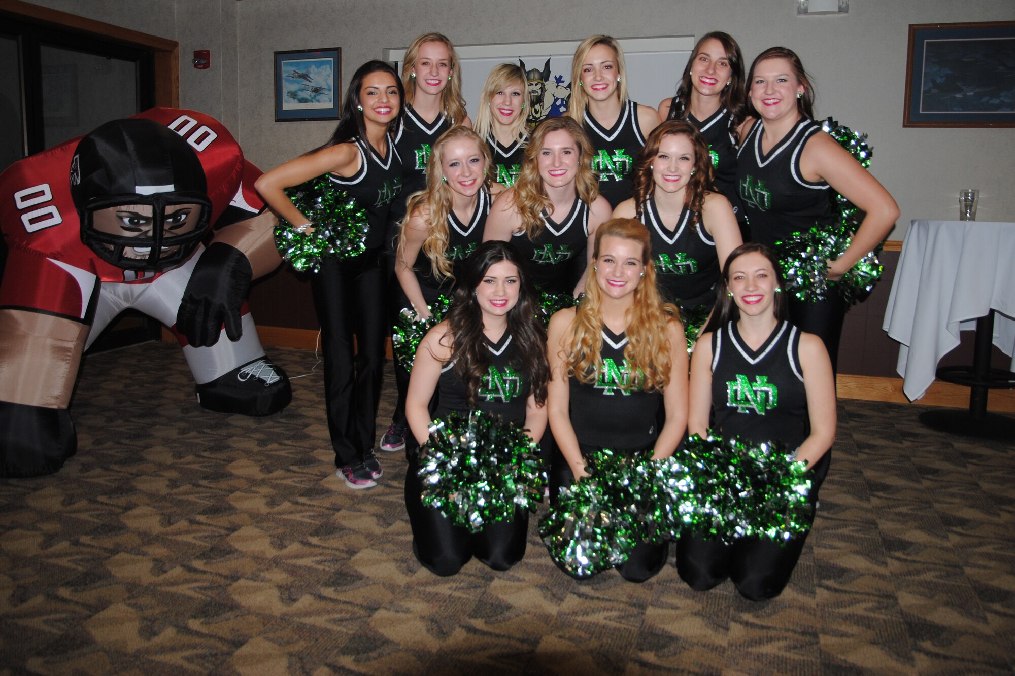 The ladies of the University of North Dakota Dance Team pose for a group photo after performing a dance routine during the 2013 Grand Forks Air Force Base Annual Awards Feb. 7, 2014, at the Northern Lights Club on Grand Forks AFB, N.D. The dancers also provided the cheering cordon to welcome nominees during introductions. (U.S. Air Force photo/Staff Sgt. Luis Loza Gutierrez) 