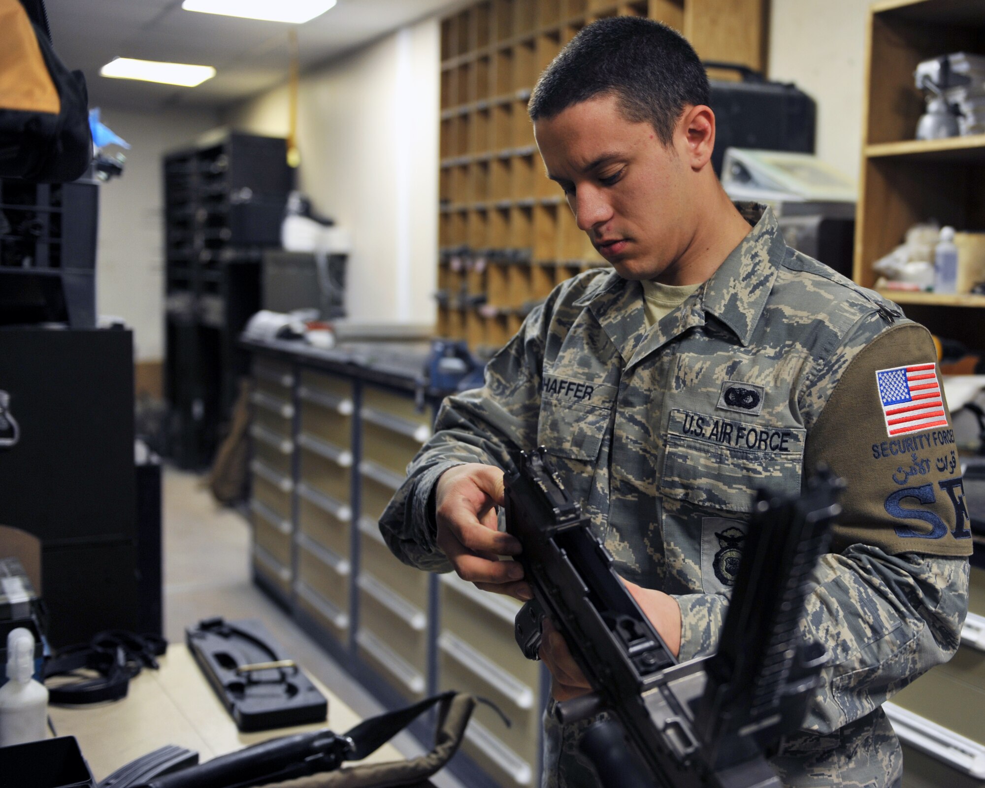 Senior Airman Josef Shaffer assembles a M240B at the 379th Expeditionary Security Forces Squadron armory, Al Udeid Air Base, Qatar, Feb. 11, 2014. The M240B is a heavy weapon that is disassembled, cleaned and assembled during the normal rotation cycle. Shaffer is a 379th ESFS armorer deployed from Luke Air Force Base, Ariz., and a Waterloo, N.Y., native. (U.S. Air Force photo by Master Sgt. David Miller)