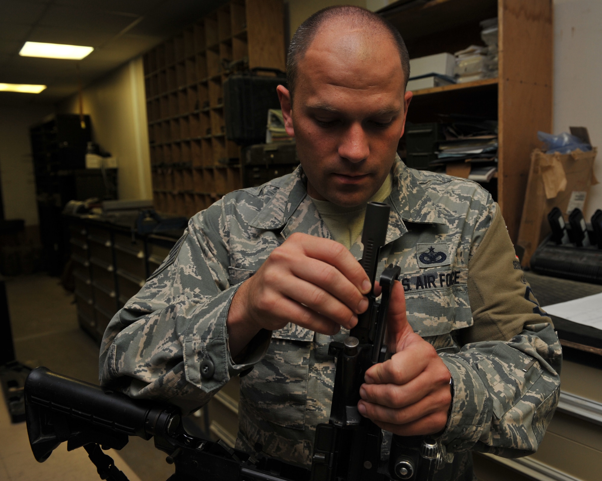 Staff Sgt. David Davis checks the headspace on the M4 Carbine rifle during an inspection at the 379th Expeditionary Security Forces Squadron armory, Al Udeid Air Base, Qatar, Feb. 11, 2014. Weapons inspections are done to ensure functionality for all 379th Air Expeditionary Wing assigned weapons. Davis is the 379th ESFS armory NCO in charge deployed from Little Rock Air Force Base, Ark., and a Little Rock, Ark., native. (U.S. Air Force photo by Master Sgt. David Miller)