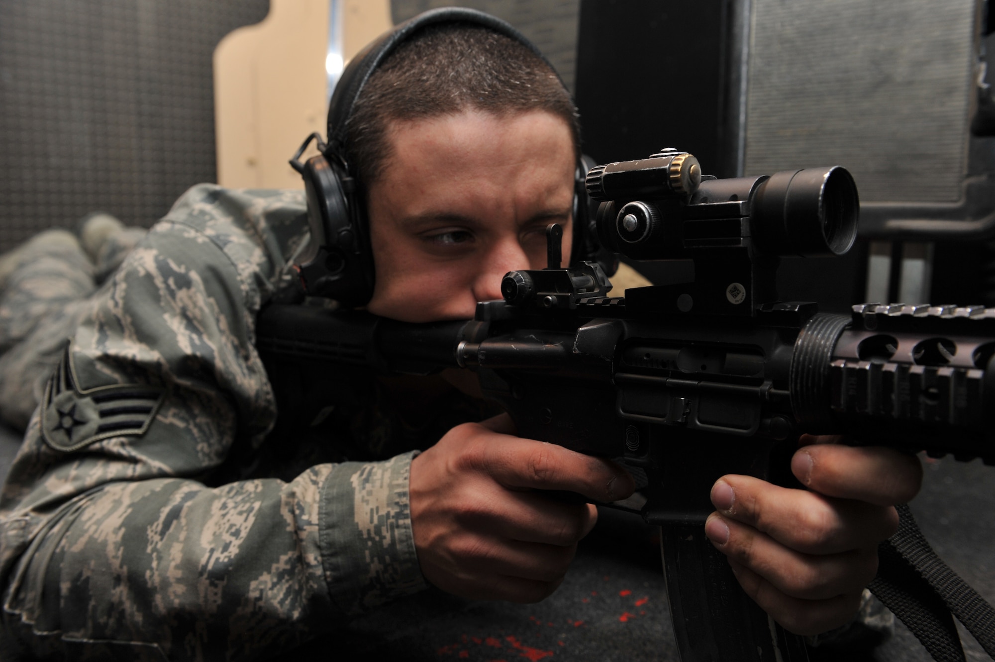 Senior Airman Josef Shaffer looks down the site of a M4 Carbine rifle at the 379th Expeditionary Security Forces Squadron mobile indoor firing range, Al Udeid Air Base, Qatar, Feb. 11, 2014. The MIFR is a 10-meter indoor range that is used for all new security forces members for zeroing weapons prepositioned at this location. Shaffer is a 379th ESFS armorer deployed from Luke Air Force Base, Ariz., and a Waterloo, N.Y., native. (U.S. Air Force photo by Master Sgt. David Miller)