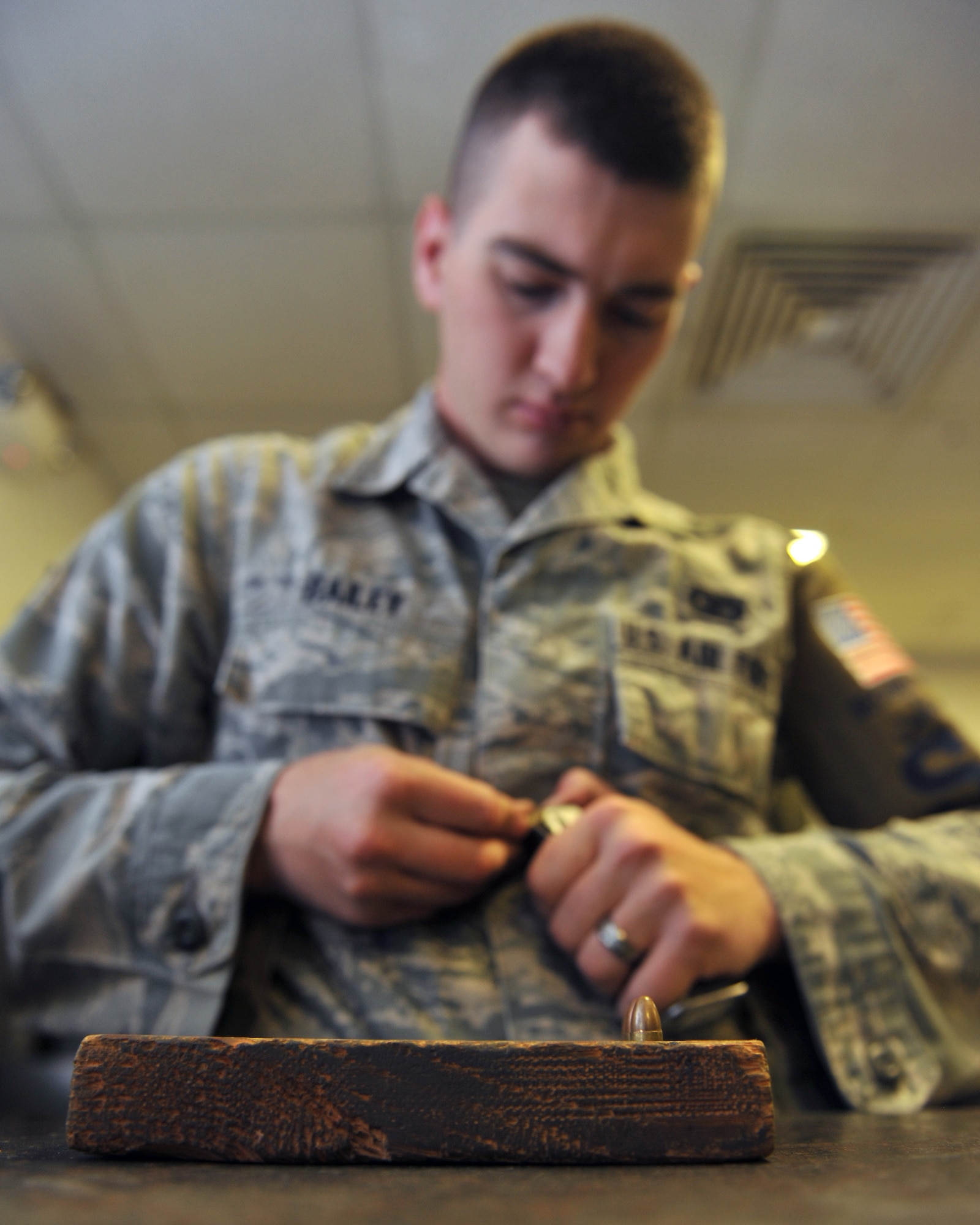Senior Airman Tim Bailey loads ball ammunition into a magazine at the 379th Expeditionary Security Forces Squadron armory, Al Udeid Air Base, Qatar, Feb. 11, 2014. Ammunition blocking is a process that ensures the correct amounts of serviceable ammunition is loaded into M4 Carbine rifle and M9 magazines. This process is done to account for all ammunition assigned to the base. Bailey is a 379th ESFS armorer deployed from Robins Air Force Base, Ga., and a Rydal, Ga., native. (U.S. Air Force photo by Master Sgt. David Miller)