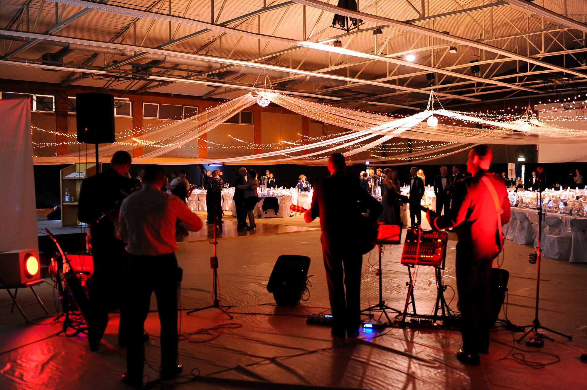 Members of Saber Nation dance as the band Weekend Duty performs after the 2013 Annual Awards Feb. 8, 2014, at Spangdahlem Air Base, Germany. The band consists of members of Saber Nation with various backgrounds in music. (U.S. Air Force photo by Senior Airman Rusty Frank/Released)