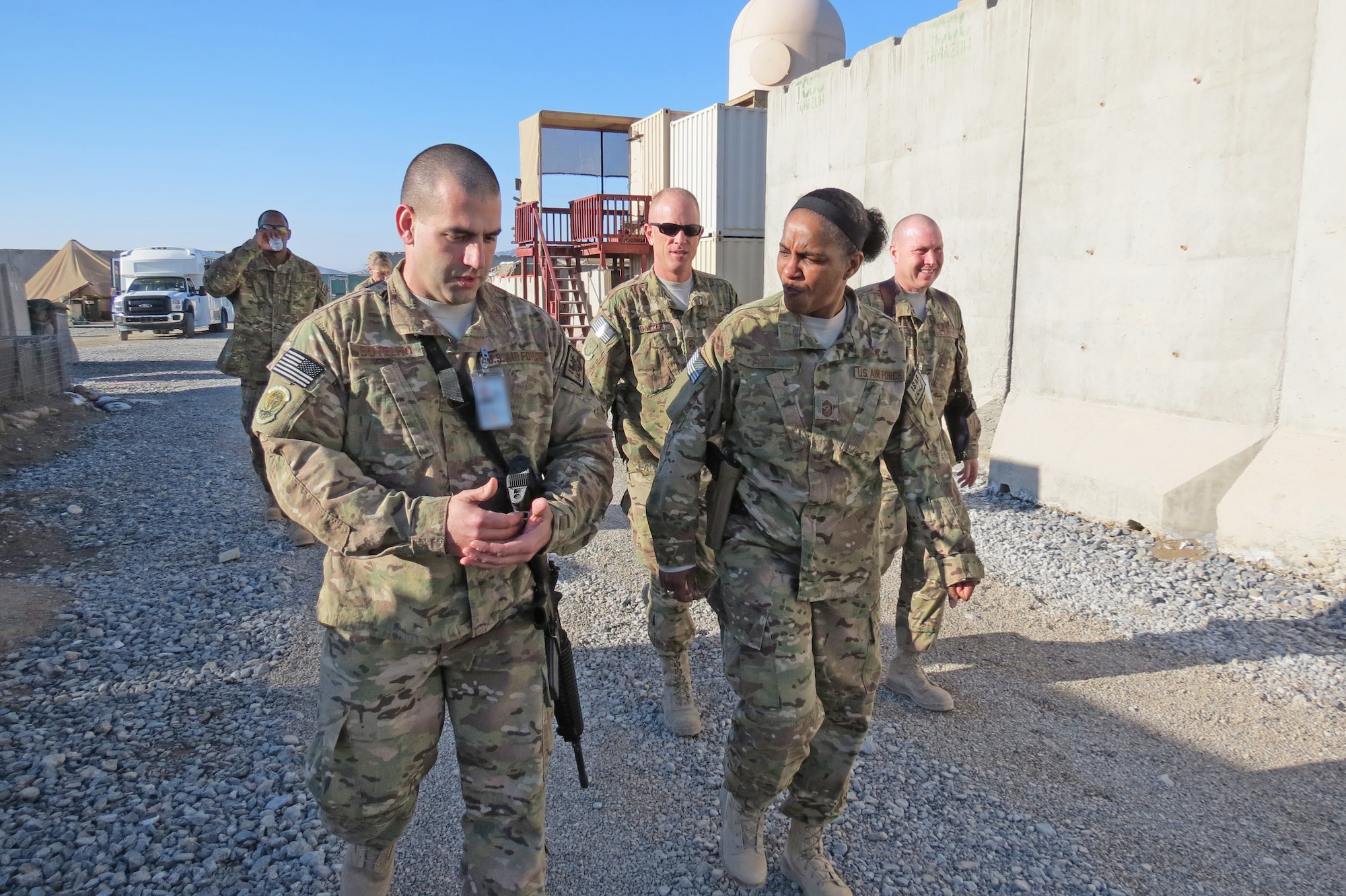 Air Force Central Command’s Command Chief Master Sgt. Shelina Frey walks with an Airman and listens to his concerns at Kandahar Airfield, Afghanistan, Feb. 12, 2014. Frey is touring bases in Afghanistan talking to Airmen and answering questions.(U.S. Air Force photo by Staff Sgt. Joseph Needham/Released)