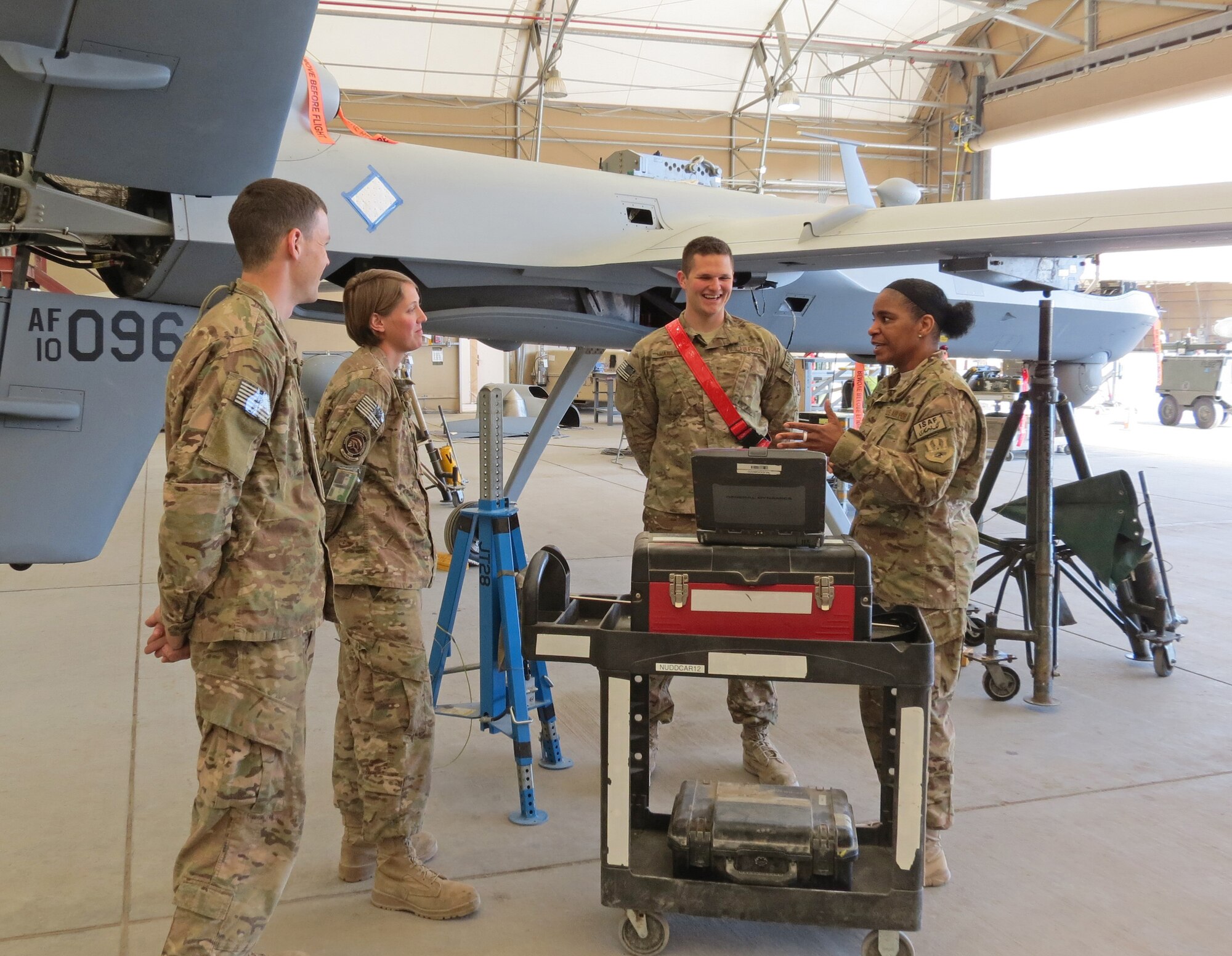 Air Force Central Command’s Command Chief Master Sgt. Shelina Frey talks to a crew that work with the Predator unmanned aerial vehicles at Kandahar Airfield, Afghanistan, Feb. 12, 2014. Frey is touring bases in Afghanistan talking to Airmen and answering questions.(U.S. Air Force photo by Staff Sgt. Joseph Needham/Released)