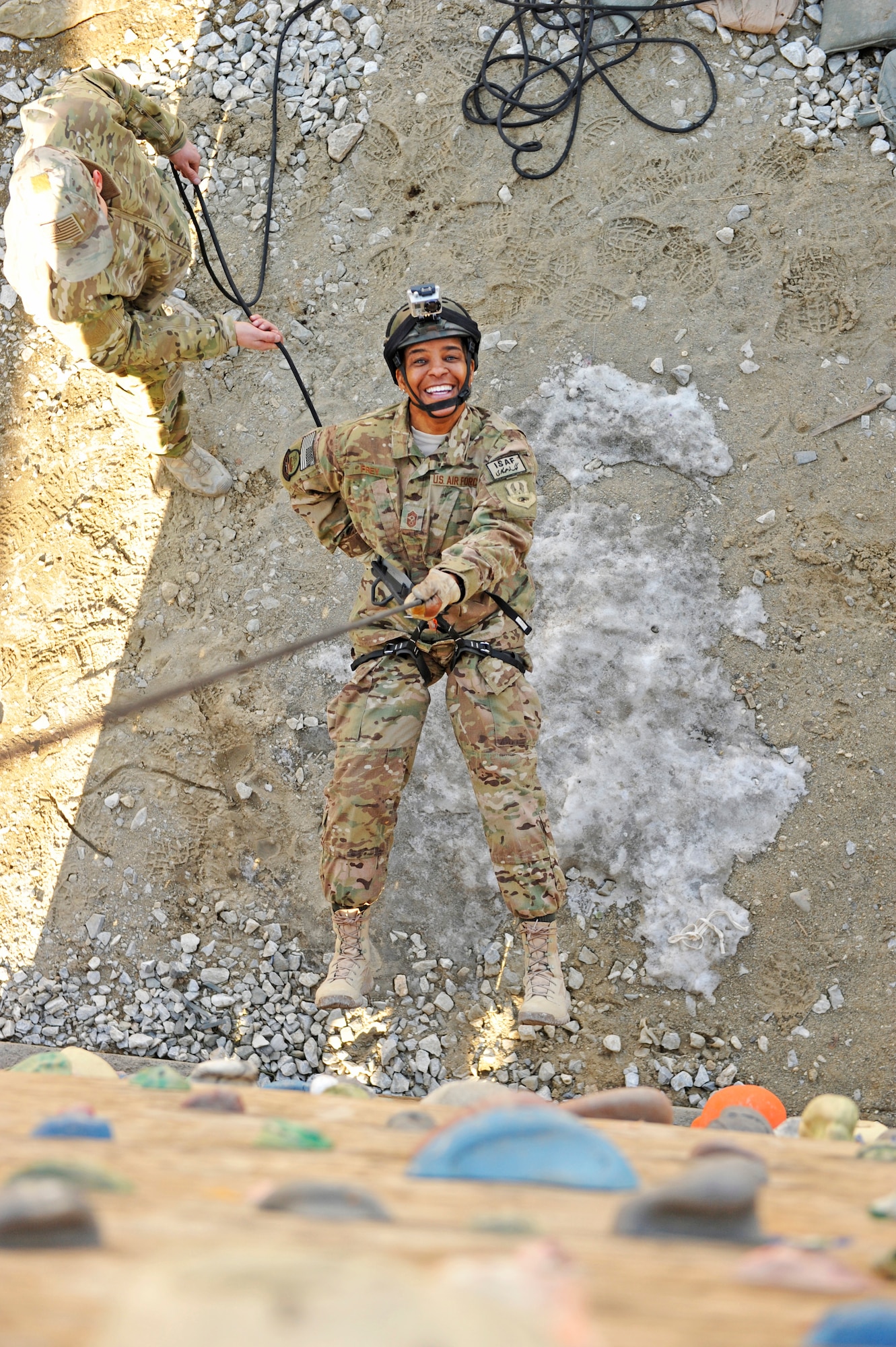 Air Force Central Command’s Command Chief Master Sgt. Shelina Frey rappels down the 83th Expeditionary Rescue Squadron’s rappelling and rock climbing training wall at Bagram Airfield, Afghanistan, Feb. 13, 2014. Frey is touring bases in Afghanistan talking to Airmen and answering questions.(U.S. Air Force photo by Senior Master Sgt. Gary J. Rihn/Released)