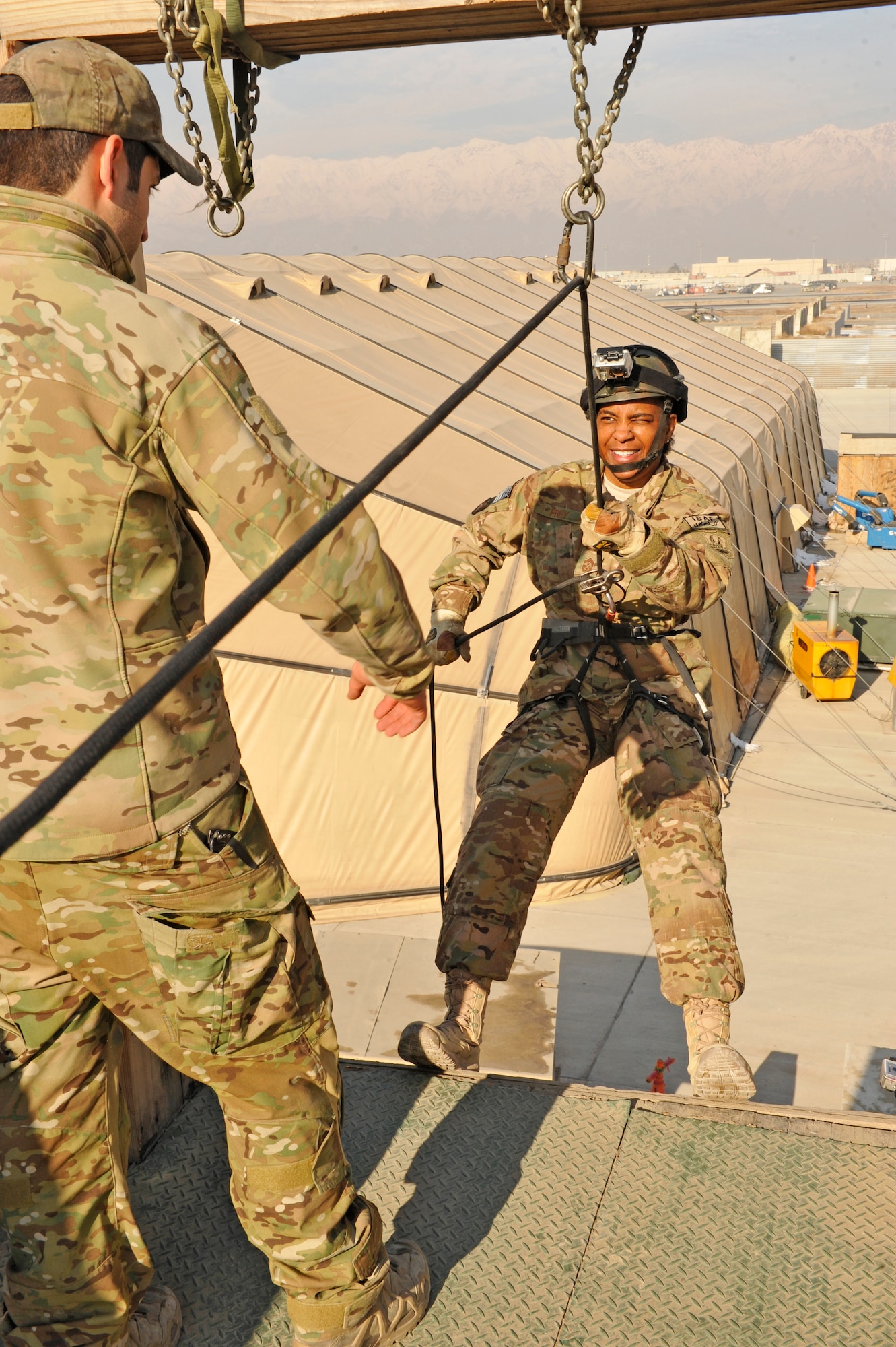 Air Force Central Command’s Command Chief Master Sgt. Shelina Frey passes the point of no return on the 83th Expeditionary Rescue Squadron’s rappelling wall at Bagram Airfield, Afghanistan, Feb. 13, 2014. Frey is touring bases in Afghanistan talking to Airmen and answering questions.(U.S. Air Force photo by Senior Master Sgt. Gary J. Rihn/Released)