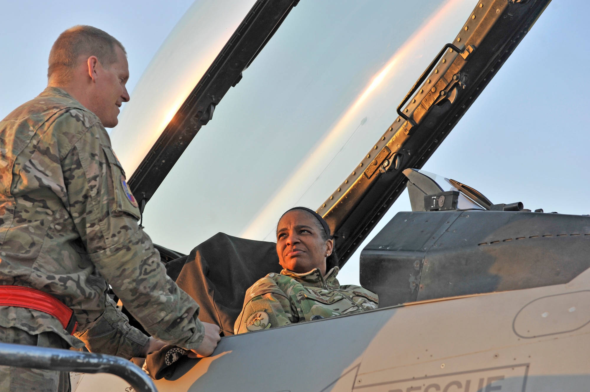 Air Force Central Command’s Command Chief Master Sgt. Shelina Frey sits in the cockpit of an F-16 Fighting Falcon while a maintainer briefs her on the capabilities of the fighter aircraft at Bagram Airfield, Afghanistan, Feb. 12, 2014. Frey is touring bases in Afghanistan talking to Airmen and answering questions.(U.S. Air Force photo by Senior Master Sgt. Gary J. Rihn/Released)