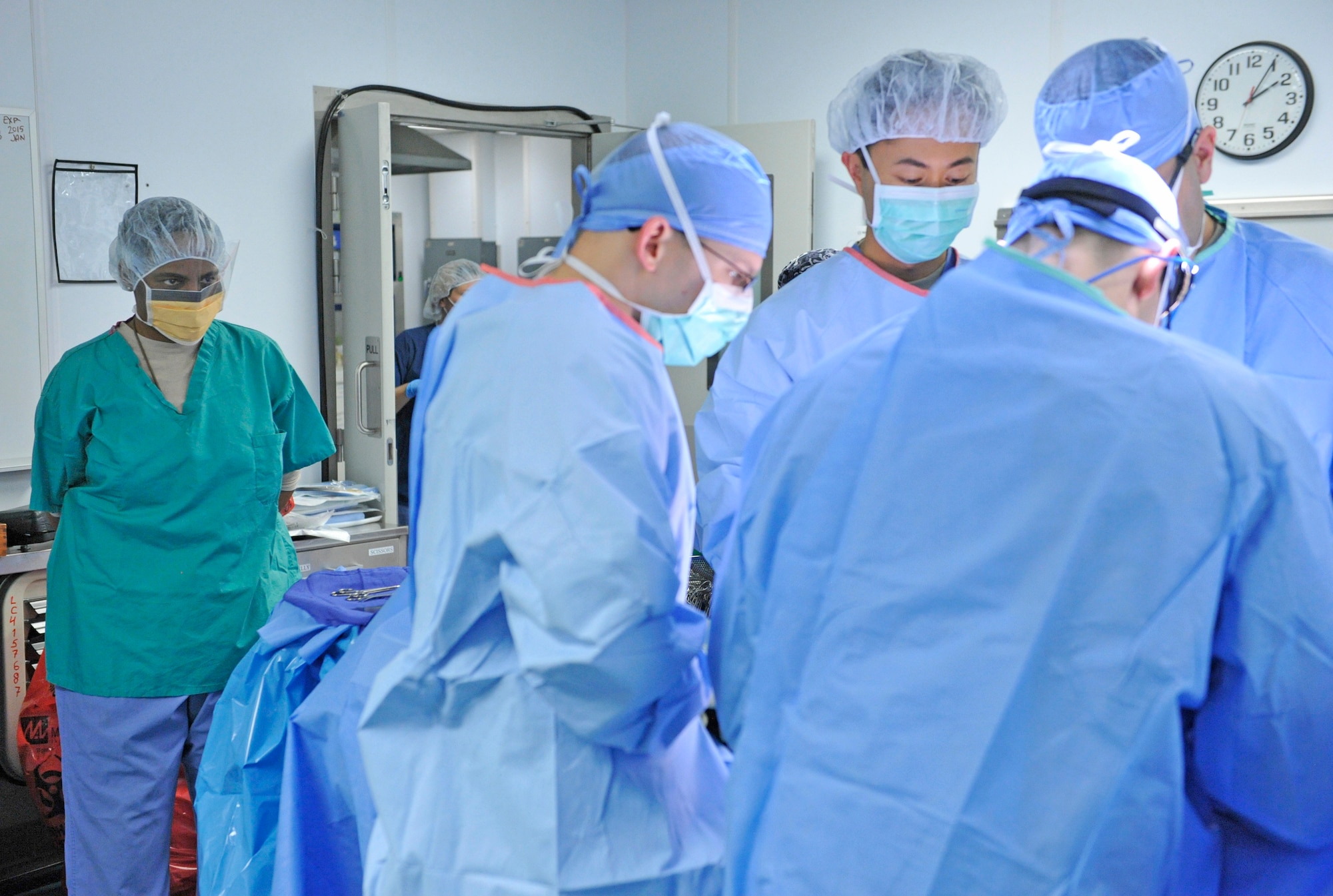 Air Force Central Command’s Command Chief Master Sgt. Shelina Frey watches as surgeons perform an operation in the operating room at the Craig Joint Theater Hospital at Bagram Airfield, Afghanistan, Feb. 12, 2014. Frey is touring bases in Afghanistan talking to Airmen and answering questions.(U.S. Air Force photo by Senior Master Sgt. Gary J. Rihn/Released)