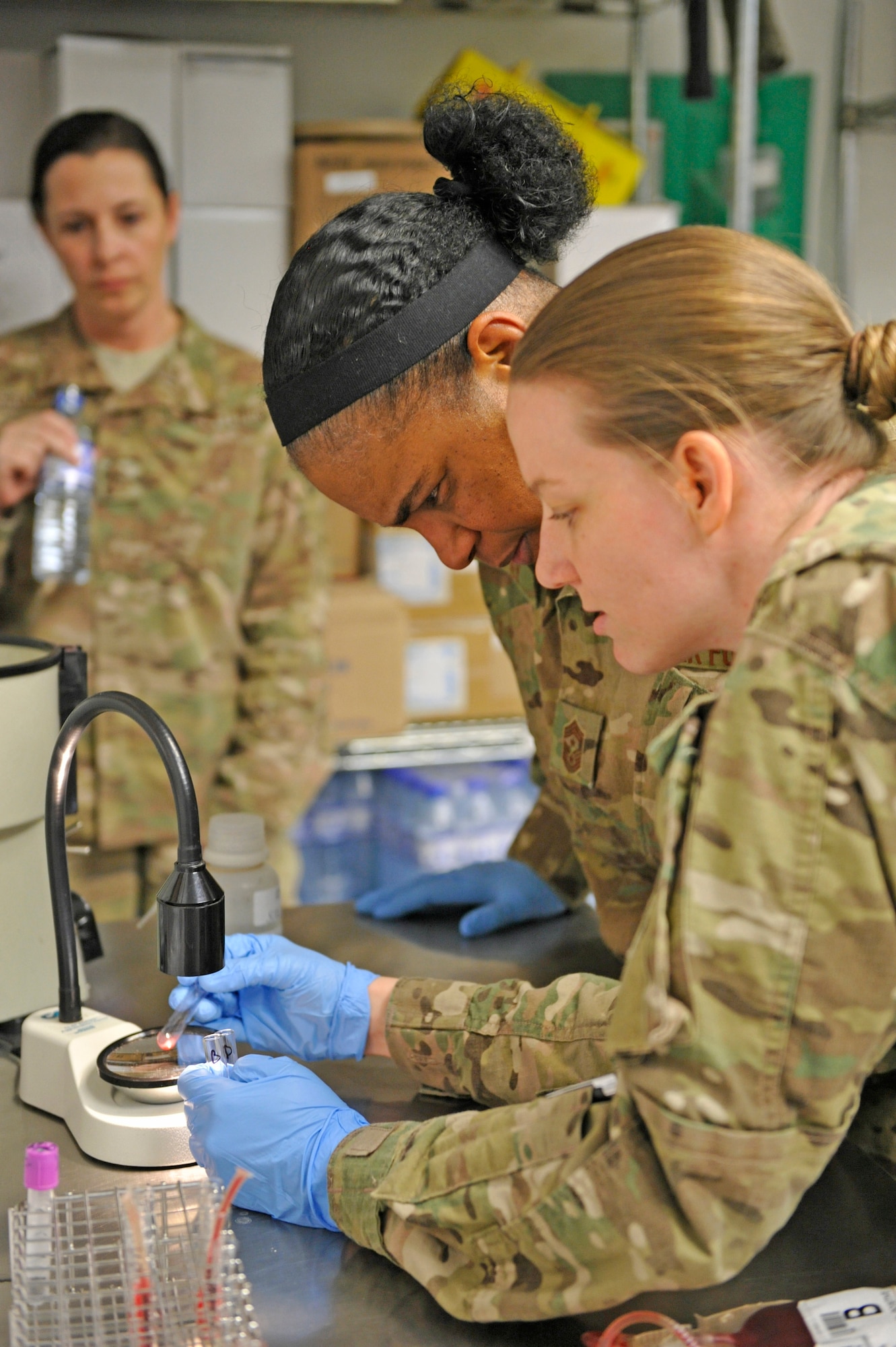 Air Force Central Command’s Command Chief Master Sgt. Shelina Frey watches as blood is tested to determine its type at the Craig Joint Theater Hospital at Bagram Airfield, Afghanistan, Feb. 12, 2014. Frey is touring bases in Afghanistan talking to Airmen and answering questions.(U.S. Air Force photo by Senior Master Sgt. Gary J. Rihn/Released)