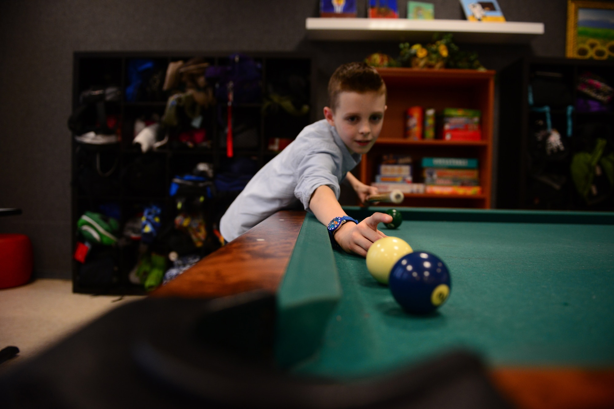 Aaron Kennedy, son of Lt. Col. John Peterson and Jennifer Kennedy Peterson, plays pool at the Aviano Youth Programs’ Open Recreation and Teen Center, Feb. 11, 2014, at Aviano Air Base, Italy. The AYP gives children the freedom to participate in different activities including video games, a pool table, arts and crafts, and school supplies. (U.S. Air Force photo/Senior Airman Matthew Lotz)