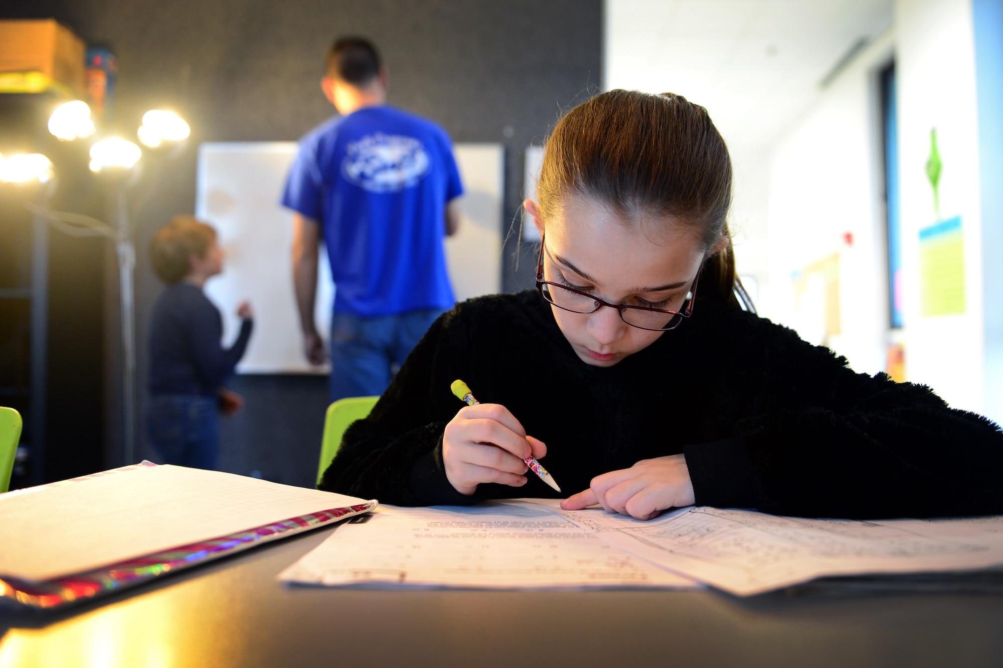 Briana Kibodeaux, daughter of Master Sgt. Nathaniel Kibodeaux and Tech. Sgt. Kathryn Kibodeaux, finishes her homework at the Aviano Youth Programs’ Open Recreation and Teen Center, Feb. 11, 2014, at Aviano Air Base, Italy. Some of the new changes the AYP made for children include: Professionally-trained staff members to assist children, more activities to choose from and for the older participants--more independence on how they want to spend their time. (U.S. Air Force photo/Senior Airman Matthew Lotz)