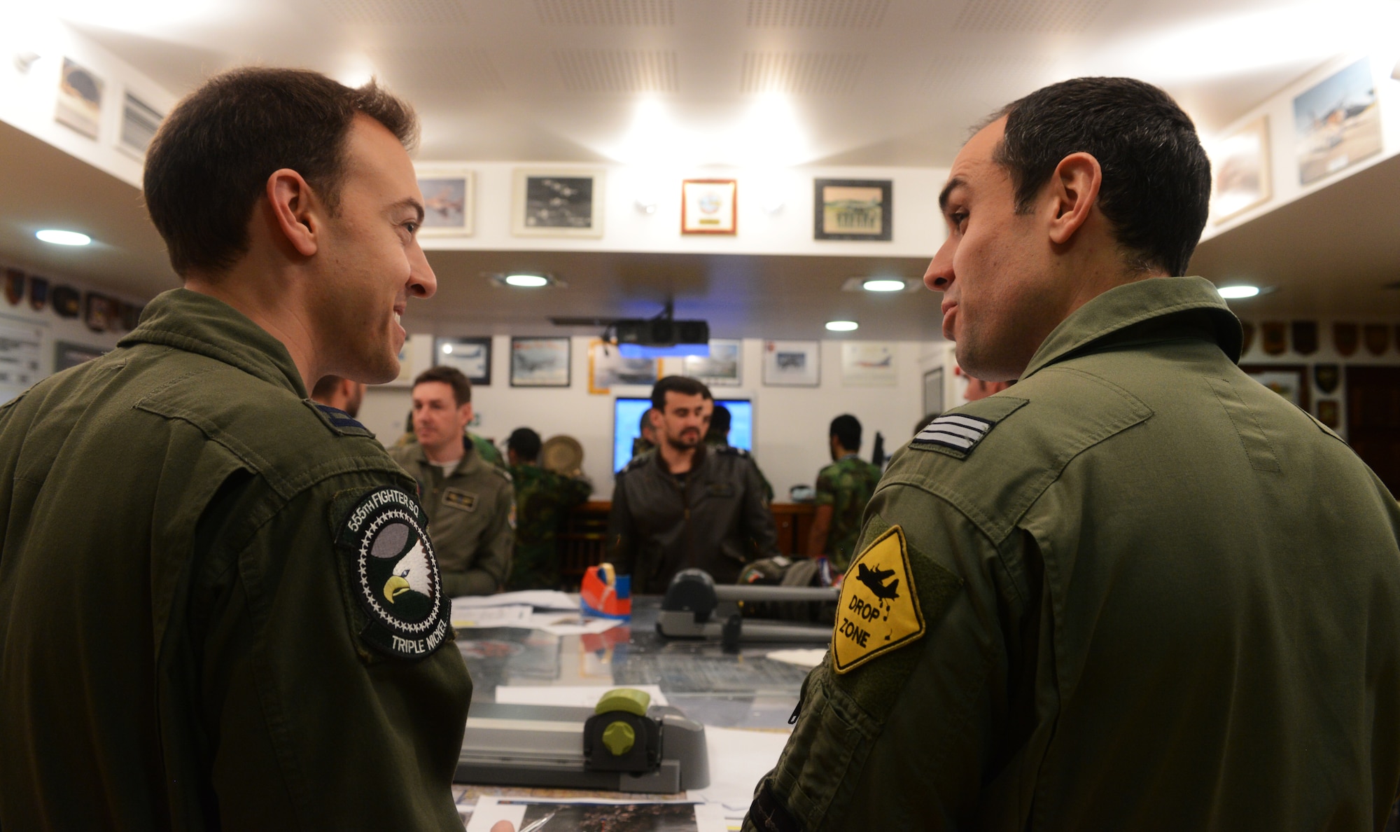 Capt. Michael Piazza, 555th Fighter Squadron F-16 Fighting Falcon pilot, briefs Capt. Rui Silva, a Portuguese C-130 Hercules pilot, Feb. 12, 2014 for an upcoming large force exercise mission at Monte Real Air Base, Portugal. Comparable to Operation Red Flag hosted at Nellis Air Force Base, Nevada, REAL THAW 14 will attract approximately 4,000 military personnel and 44 aircraft from the U.S., Netherlands, Portugal and NATO. (U.S. Air Force photo/2nd Lt. Allie Delury)
