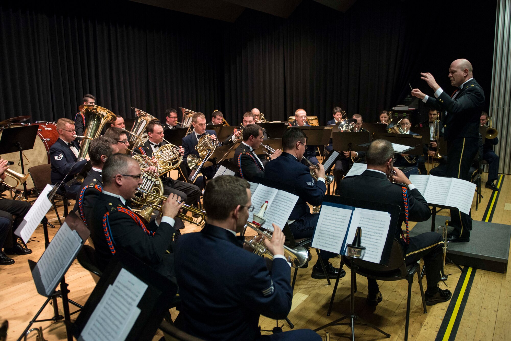 Luxembourg Air Force Capt. Jean-Claude Braun, Luxembourg Musique Militaire chief of music, conducts both the Luxembourg band and the U.S. Air Forces in Europe Band brass ensemble during a performance Feb. 11, 2014, at the Mehrzweckhalle in Kenn, Germany. The Luxembourg Musique Militaire and USAFE brass ensemble are touring through France, Belgium, Germany and Luxembourg. (U.S. Air Force photo by Staff Sgt. Christopher Ruano/Released)