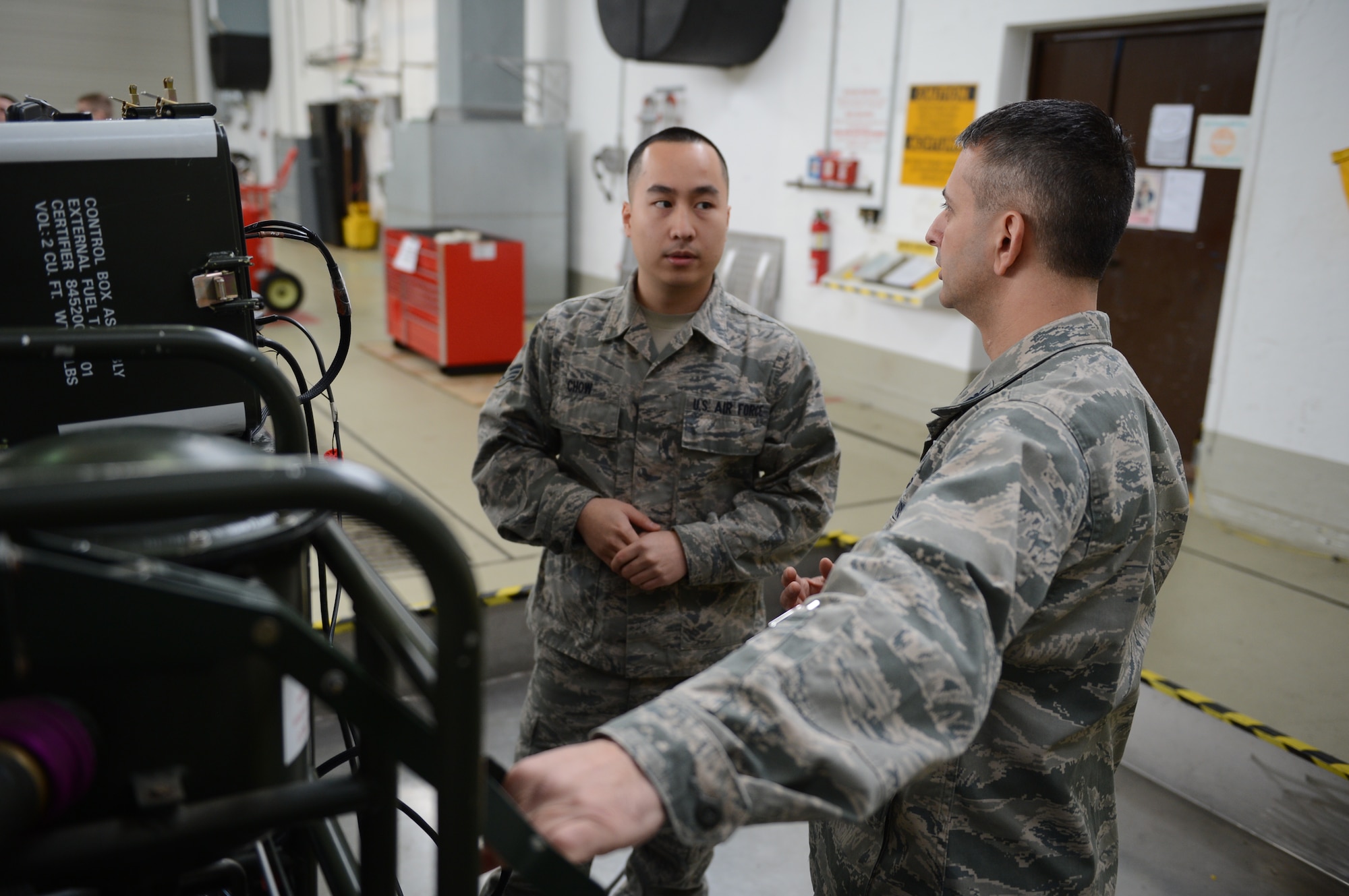 U.S. Air Force Col. David Julazadeh, 52nd Fighter Wing commander, pumps jet fuel into a fuel tank with Senior Airman Brandon Chow, 52nd Component Maintenance Squadron fuel systems journeyman, at Spangdahlem Air Base, Germany, Feb. 10, 2014. Julazadeh helped Chow complete a maintenance process to troubleshoot an incorrect quantity reading. (U.S. Air Force photo by Airman 1st Class Kyle Gese/Released)