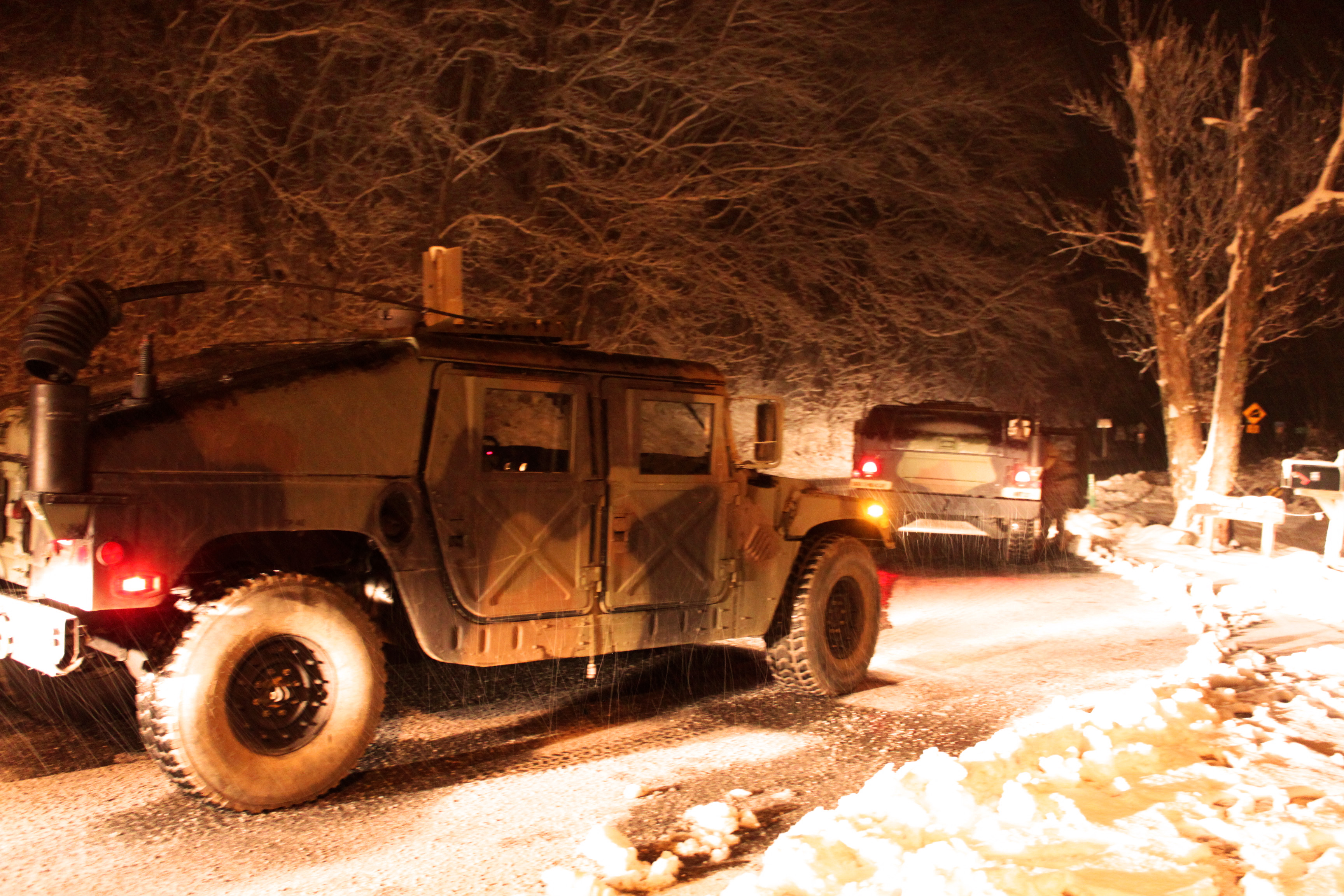 Soldiers Ride In Humvees While Checking Roads And Providing