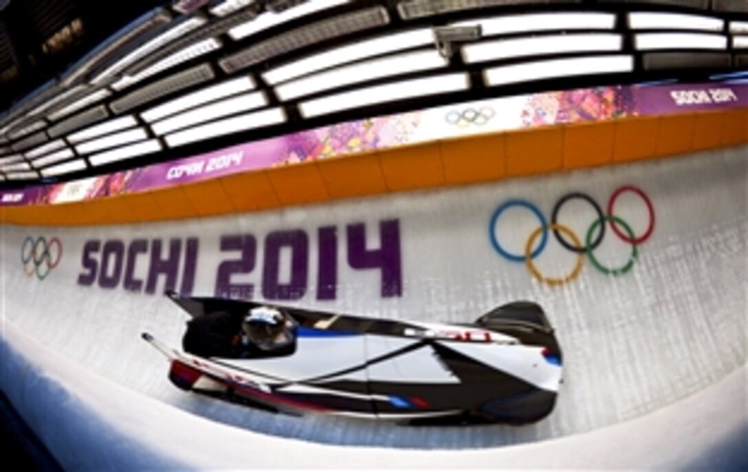 U. S. Army Sgt. Nick Cunningham, the bobsled driver, and Army Sgt. Dallas Robinson, the brakeman, are clocked at 81.4 mph as the seventh-fastest among 30 sleds in the second heat of Olympic two-man bobsled training with a time of 57.19 seconds at Sanki Sliding Centre in Krasnaya Polyana, Russia, Feb. 13, 2014. Cunningham, a New York National Guardsman, and Robinson, a Kentucky National Guardsman, are assigned to the U.S. Army World Class Athlete Program.