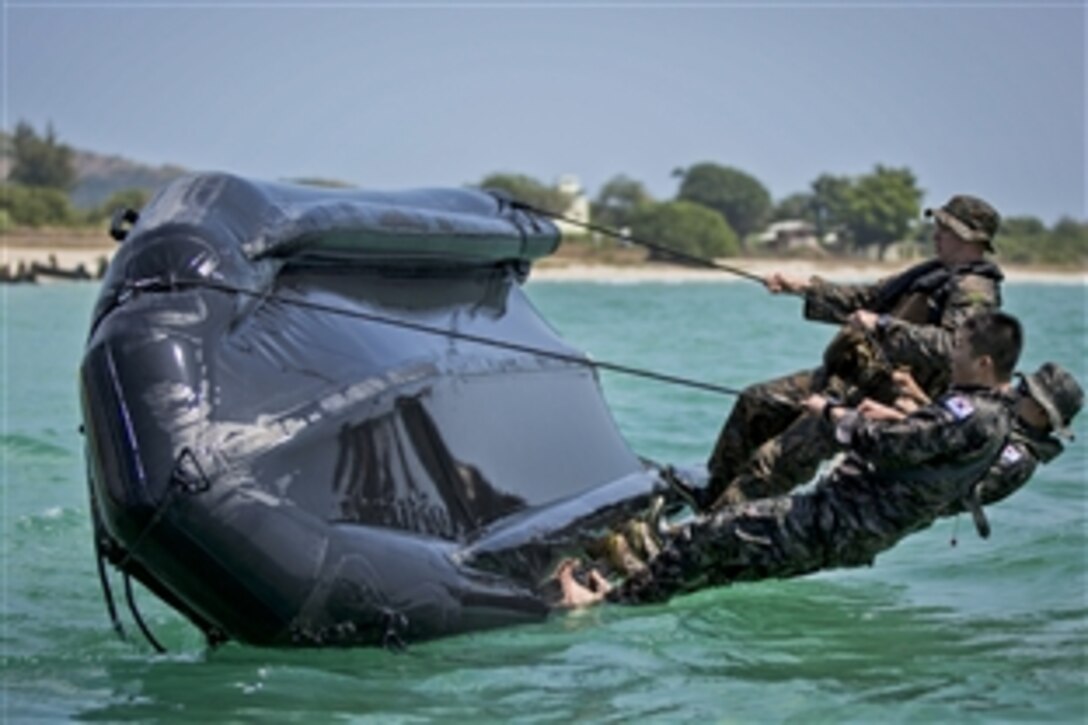 South Korean and U.S. Marines attempt to flip a boat as they conduct amphibious operations drills during Cobra Gold 2014 at Hat Yao in Rayong,Thailand, Feb. 12, 2014. The exercise demonstrates the commitment by the United States and Thailand to a long-standing alliance and regional partnership in the Asia-Pacific region. U.S. Marines assigned to the 3rd Marine Division's 3rd Reconnaissance Battalion, 3rd Marine Expeditionary Force participated in the drills.