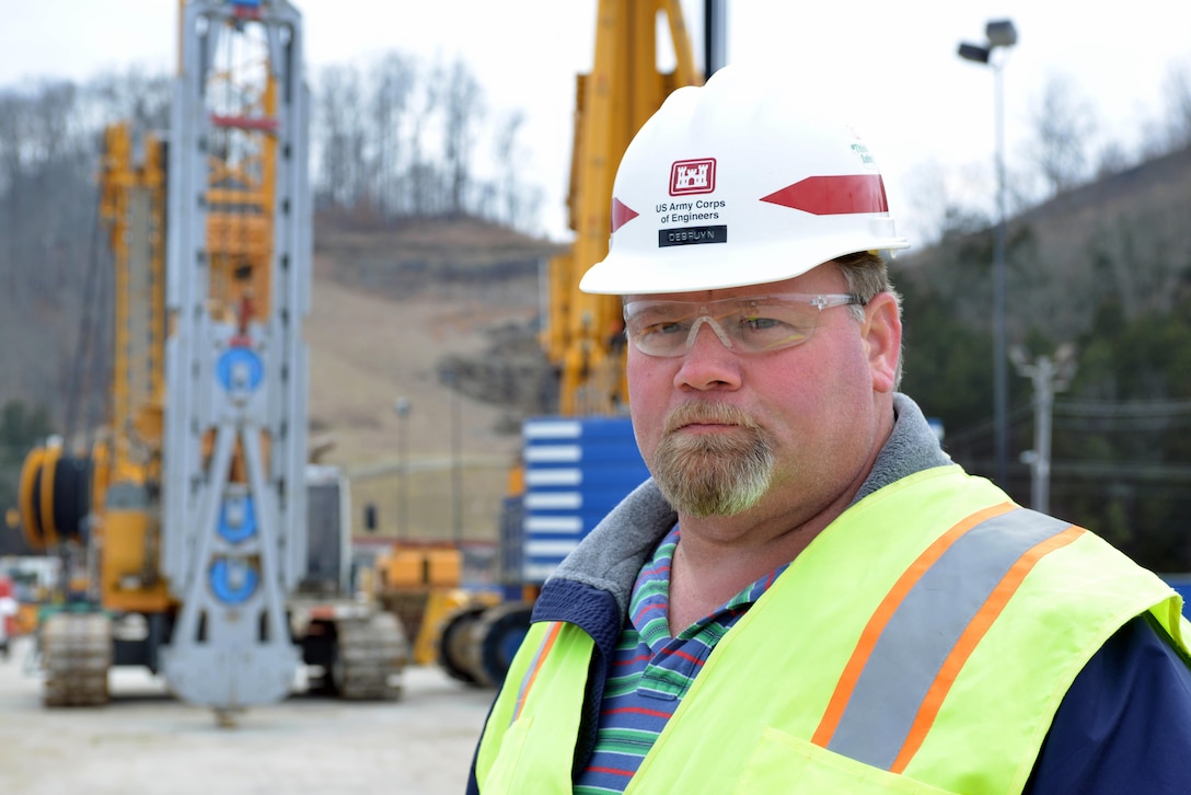 Center Hilld Dam foundation rehabilitation construction resident engineer Bill Debruyn watches crews work from the Bauer Foundation Corporation repair a large drill excavator at the project at the Center Hill Dam in Lancaster, Tenn. Feb. 6, 2014.  Debruyn says using today’s technology makes it possible for repairs deep in the foundation. 