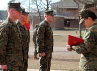 Sgt. Jeremy Moses (far left), Cpl. Myles Bayer (left center) and Lance Cpl. Adam Dwaileebe (center), all motor transportation operators with Transportation and Support Company, Combat Logistics Battalion 2, 2nd Marine Logistics Group, stand at attention in front of Lt. Col. William Stophel (far right), the commanding officer of CLB-2 and Sgt. Maj. Charmalyn Pile, the battalion sergeant major, during a Purple Heart Medal ceremony aboard Camp Lejeune, N.C., Feb. 7, 2014.  The three Marines were awarded the Purple Heart for wounds suffered in action while deployed in support of Operation Enduring Freedom.