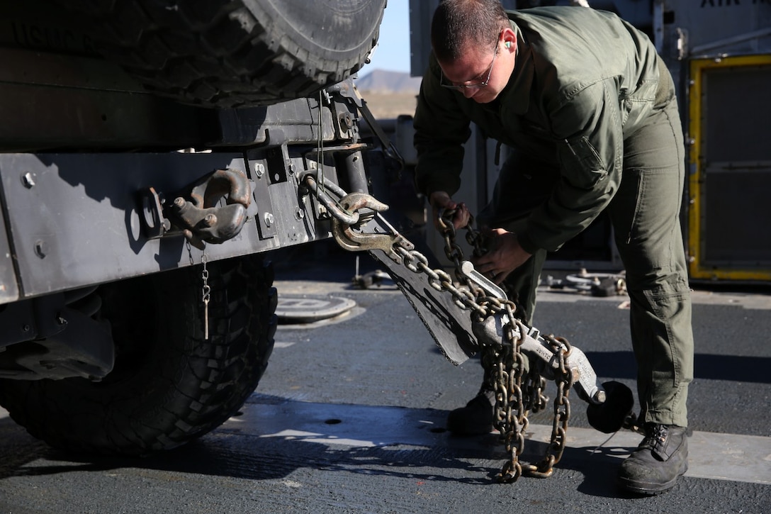 Petty Officer 3rd Class Matthew Garcia, gas service system mechanic, Assault Craft Unit 5, secures a High Mobility Multipurpose Wheeled Vehicle on a Landing Craft Air Cushion to be transported to San Clemente Island during Exercise Iron Fist 2014 aboard Camp Pendleton, Calif., Feb. 12, 2014. Iron Fist is an amphibious exercise that brings together Marines and sailors from the 15th Marine Expeditionary Unit, other I Marine Expeditionary Force units, and soldiers from the JGSDF, to promote military interoperability and hone individual and small-unit skills through challenging, complex and realistic training. (U.S. Marine Corps photo by Lance Cpl. Ricardo Hurtado/Released)