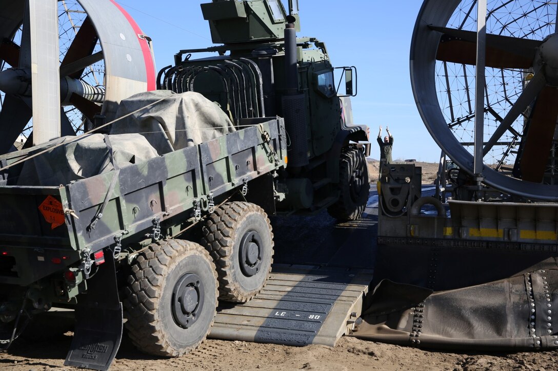 A 7-ton Medium Tactical Vehicle Replacement gets loaded onto a Landing Craft Air Cushion to be transported to San Clemente Island during Exercise Iron Fist 2014 aboard Camp Pendleton, Calif., Feb. 12, 2014. Iron Fist is an amphibious exercise that brings together Marines and sailors from the 15th Marine Expeditionary Unit, other I Marine Expeditionary Force units, and soldiers from the JGSDF, to promote military interoperability and hone individual and small-unit skills through challenging, complex and realistic training. (U.S. Marine Corps photo by Lance Cpl. Ricardo Hurtado/Released)