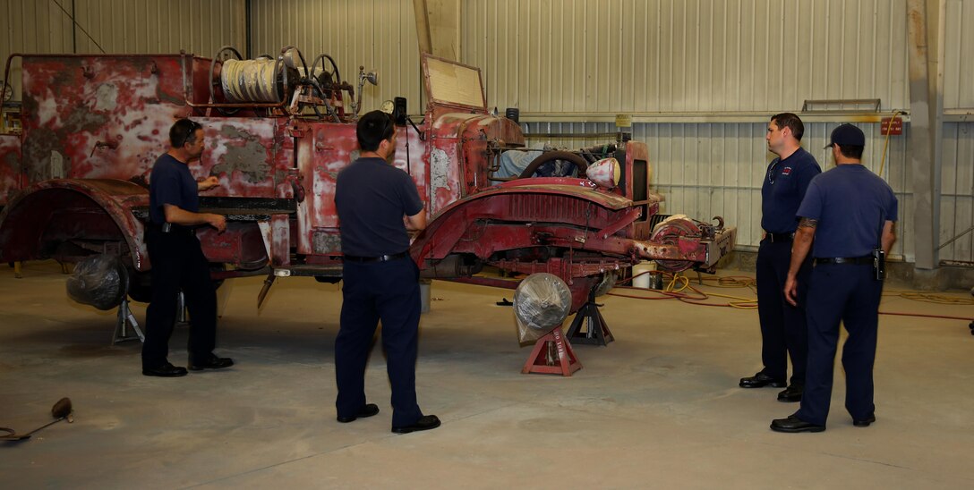 Firefighters with the Miramar Fire Department look over a 1944 International Harvester FFN-3 fire and crash crew engine at the Flying Leatherneck Aviation Museum warehouse aboard Marine Corps Air Station Miramar, Calif., Feb. 12. The firemen came to view the rusty, red engine as part of their history before the restorative processes begin in earnest.