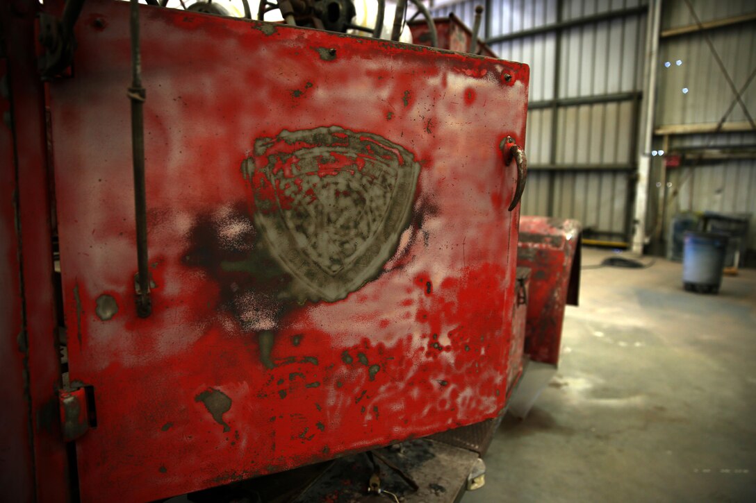 Faded symbols decorate the door of a 1944 International Harvester FFN-3 fire and crash crew engine at the Flying Leatherneck Aviation Museum warehouse aboard Marine Corps Air Station Miramar, Calif., Feb. 12. The World War II-era fire engine is slated to be refurbished by June for the San Diego County Fair.