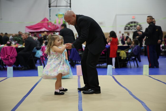 Gunnery Sgt. Michael H. Wample, cheif drill instructor, Special Training Company, Support Battalion, dressed up in his suit for the 7th annual Father-Daughter Dance, dances with his young daughter aboard the depot, Jan. 31. A service members job can take a lot of time away from family, but events such as this helps get back some of the lost time.  