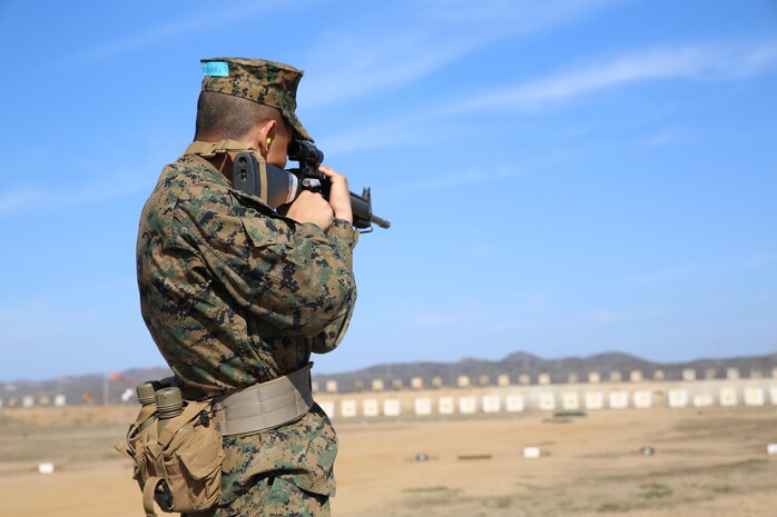 Recruit Jose M. Guerrero, Platoon 3215, Company I, 3rd Recruit Training Battalion, aims in at the target in the standing position from the 300-yard line at Edson Range, Jan. 27. Recruits fired from the 200-, 300- and 500-yard lines in order to qualify