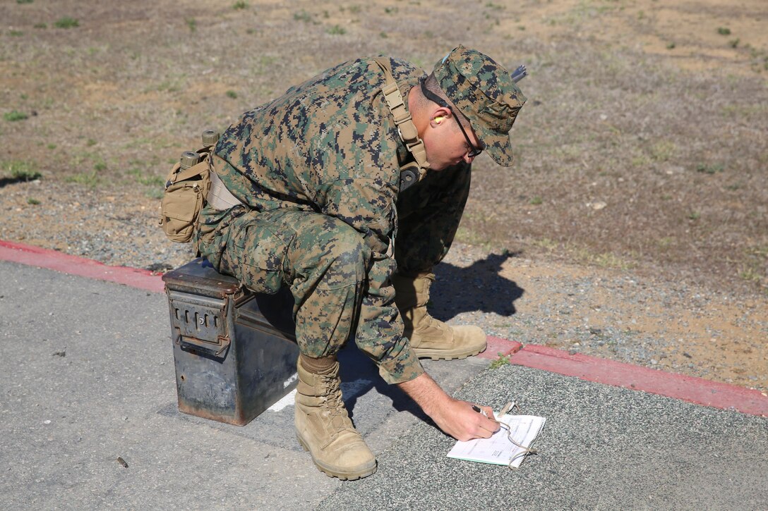 Recruit Colton E. Dirks, Platoon 3215, Company I, 3rd Recruit Training Battalion, records his last shot in his rifle data book at Edson Range, Jan. 27. Each recruit received a rifle data book and had to record all of their shots for each target they fired at.