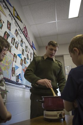 U.S. Marine Corps Cpl. William O'Keeffe, 26th Marine Expeditionary Unit (MEU) cyber network operator, interacts with students at Swansboro Elementary School as parts of the 26th MEU's partnership with the school in Swansboro, N.C., Feb. 14, 2014. (U.S. Marine Corps photo by Staff Sgt. Edward Guevara/Released)