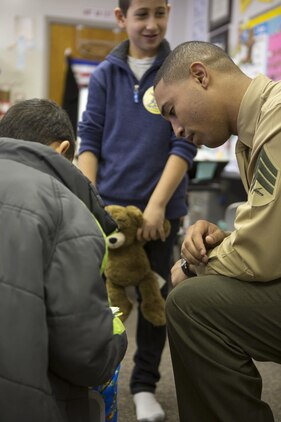 U.S. Marine Corps Sgt. Calvin Eberhardt, 26th Marine Expeditionary Unit (MEU) admin clerk, interacts with students at Swansboro Elementary School as parts of the 26th MEU's partnership with the school in Swansboro, N.C., Feb. 14, 2014. (U.S. Marine Corps photo by Staff Sgt. Edward Guevara/Released)