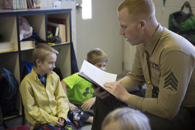 U.S. Marine Corps Sgt. Matthew Davies, 26th Marine Expeditionary Unit (MEU) radio chief, interacts with students at Swansboro Elementary School as parts of the 26th MEU's partnership with the school in Swansboro, N.C., Feb. 14, 2014. (U.S. Marine Corps photo by Staff Sgt. Edward Guevara/Released)