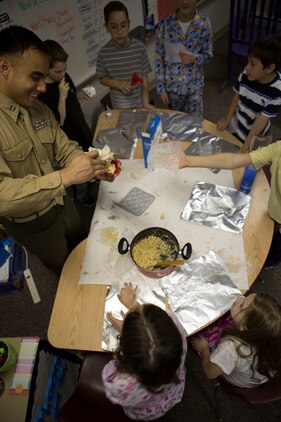 U.S. Marine Corps Capt. Lucas Burke, 26th Marine Expeditionary Unit (MEU) public affairs officer, interacts with students at Swansboro Elementary School as parts of the 26th MEU's partnership with the school in Swansboro, N.C., Feb. 14, 2014. (U.S. Marine Corps photo by Staff Sgt. Edward Guevara/Released)