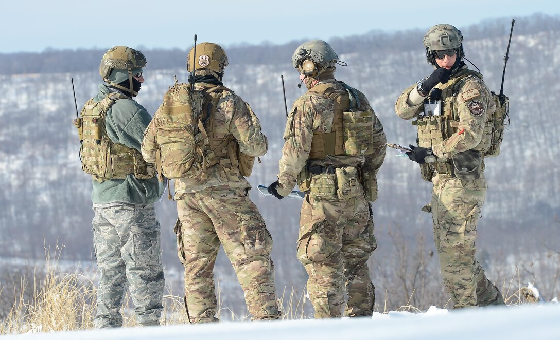 Staff Sgt. Steven Stein (right) works with members of his joint terminal attack controller team to plot targets during a joint training exercise Feb. 6, 2014, at the Bollen Live-Fire Range Complex on Fort Indiantown Gap, Pa. The JTACs worked with C-17A Globemaster IIIs and A-10C Thunderbolt IIs in the mountainous, snowy terrain of central Pennsylvania. Stein is a JTAC from the 11th Air Support Operations Squadron, 3rd Air Support Group, which supports the U.S. Army's 3rd Armored Calvary Regiment at Fort Hood, Texas. (U.S. Air Force photo/Greg L. Davis)
