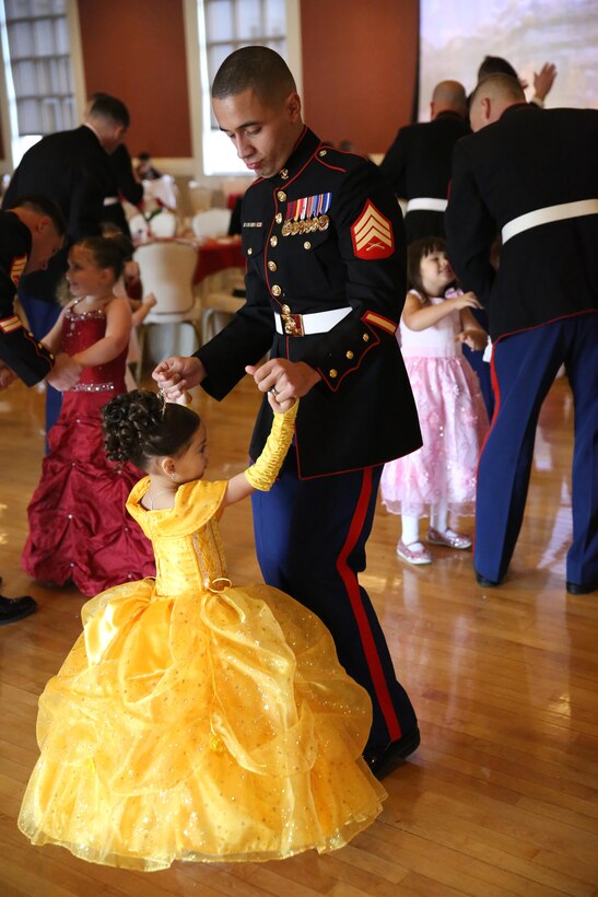 A Marine and his daughter enjoy dancing and festivities at the Tiny Miss Daddy-Daughter Dance held Feb. 8, 2014 at the Marston Pavilion aboard Marine Corps Base Camp Lejeune.