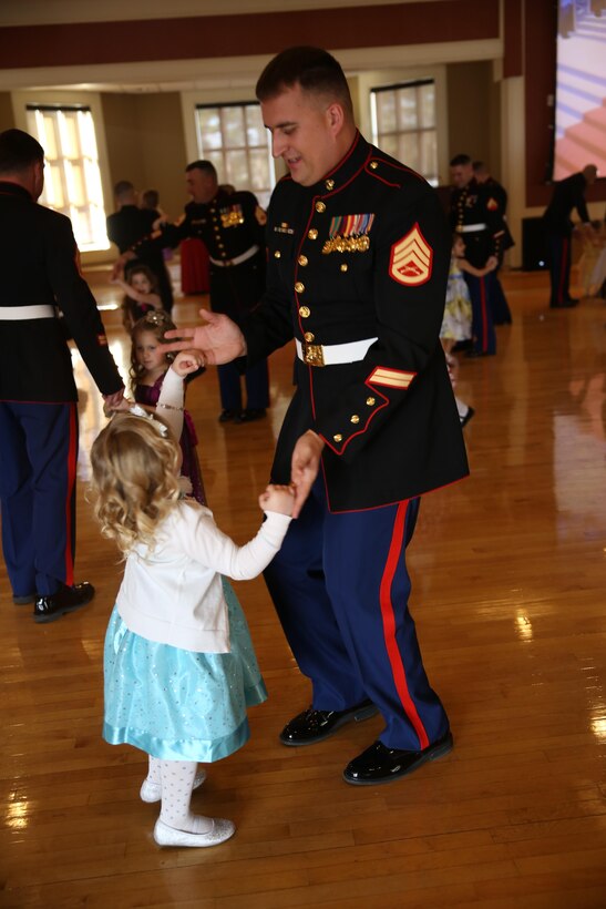 Staff Sergeant John Wallerich and his daughter Ava enjoy dancing at the Tiny Miss Daddy-Daughter Dance held Saturday, Feb. 8, 2014 at the Marston Pavilion aboard Marine Corps Base Camp Lejeune.