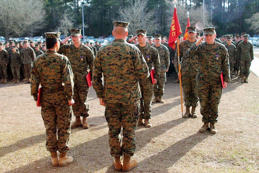 Sgt. Jeremy Moses (left), Cpl. Myles Bayer (center) and Lance Cpl. Adam Dwaileebe (right), all motor transportation operators with Transportation and Support Company, Combat Logistics Battalion 2, 2nd Marine Logistics Group, salute Lt. Col. William Stophel, the commanding officer of CLB-2 and Sgt. Maj. Charmalyn Pile, the battalion sergeant major, during a Purple Heart Medal ceremony aboard Camp Lejeune, N.C., Feb. 7, 2014. The three Marines were awarded the Purple Heart for wounds suffered in action while deployed in support of Operation Enduring Freedom.