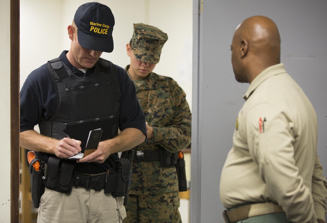 A civilian student and Marine work together in an evidence-gathering exercise with Robby D. Mask (right), an instructor at the Marine Corps Police Academy West, aboard Marine Corps Air Station Miramar, Calif., Feb. 11. Marine and civilian students work together at the academy during a 12-week course.