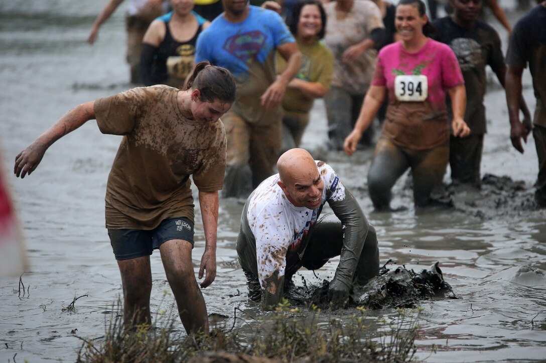 Participants in the Swamp Romp trudge through the mud of Nu'upia Ponds during the 3.5 mile run Feb. 8, 2014. The run has been held annually for 20 years and was open to the public. (U.S. Marine Corps photo by Cpl. Sarah Dietz)