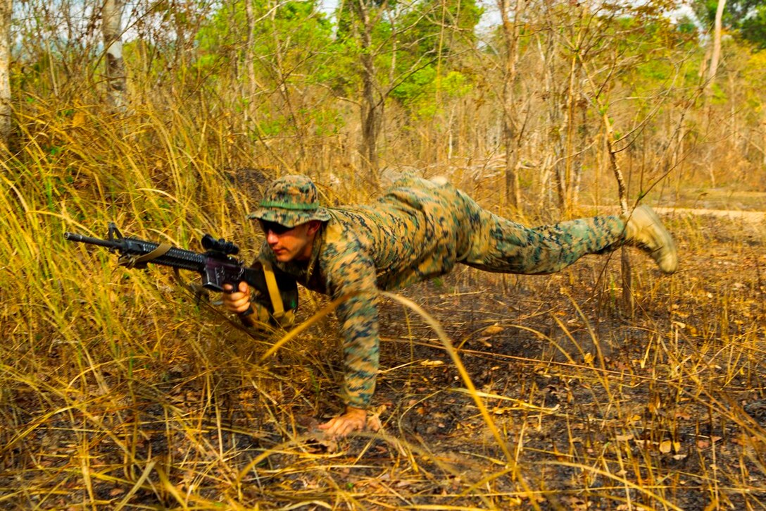 Lance Cpl. Beto A. Chavarria leaps to a low profile position Feb. 12 at Ban Chan Krem, Kingdom of Thailand during Exercise Cobra Gold. Cobra Gold is a multinational and multiservice exercise, which takes place annually in the Kingdom of Thailand and was developed by the Thai and U.S. militaries. The day's training evolution consisted of Royal Thai Marines and U.S. Marines practicing various jungle patrolling tactics, techniques and procedures. Chavarria is a rifleman with Lima Company, 3rd Battalion, 1st Marine Regiment, which is currently attached to 4th Marines, 3rd Marine Division, III Marine Expeditionary Force, as part of the Marine Corps' unit deployment program.