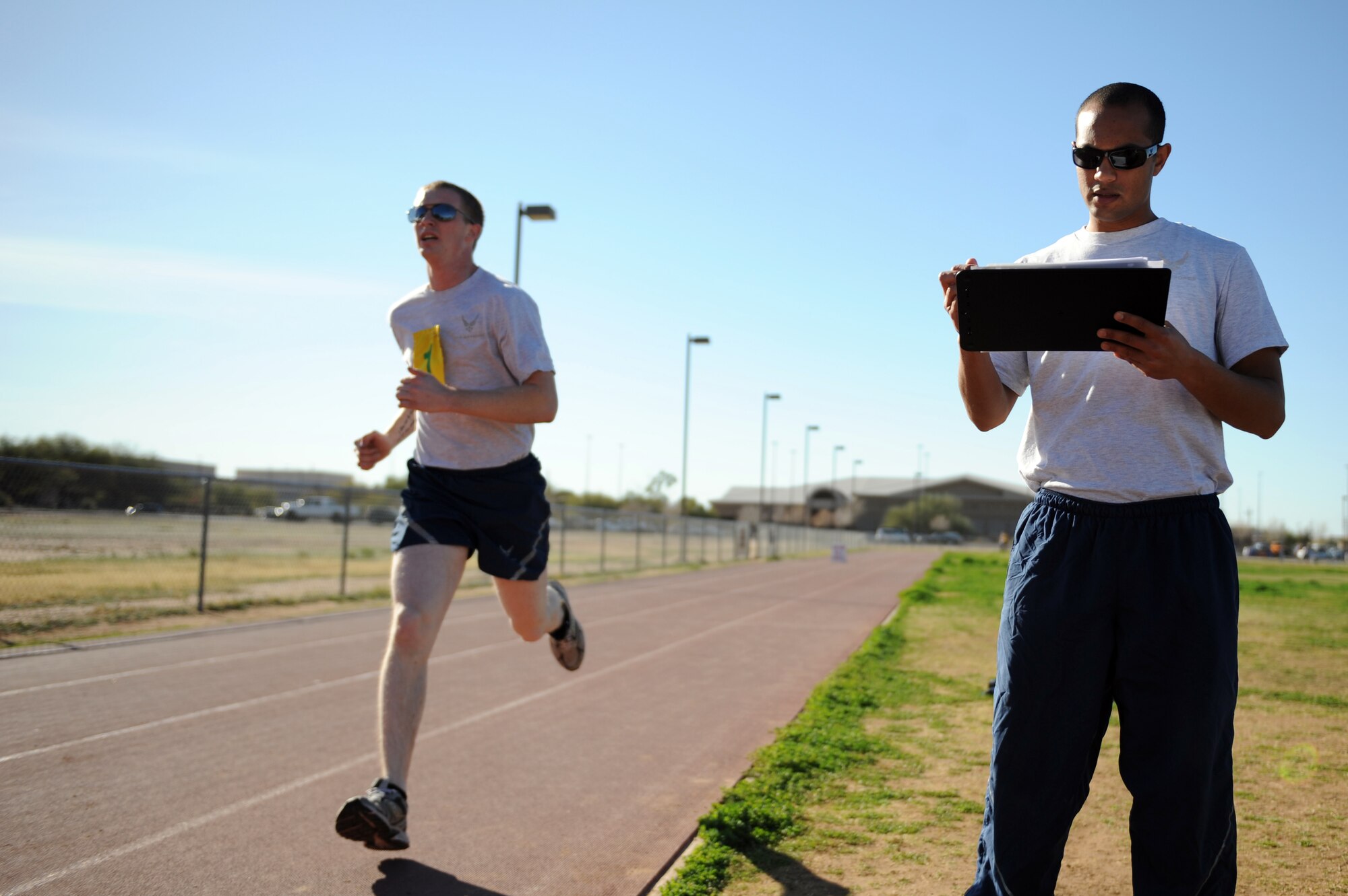 U.S. Air Force Senior Airman Timothy Stephens, 355th Logistics Readiness Squadron, fuel journeyman, scores other Airmen on their physical training tests during Fitness Assessment Cell detail at Davis-Monthan Air Force Base, Ariz., Feb. 11, 2014. The FAC detail is rotated among each squadron at D-M. (U.S. Air Force photo by Airman 1st Class Chris Drzazgowski/Released)