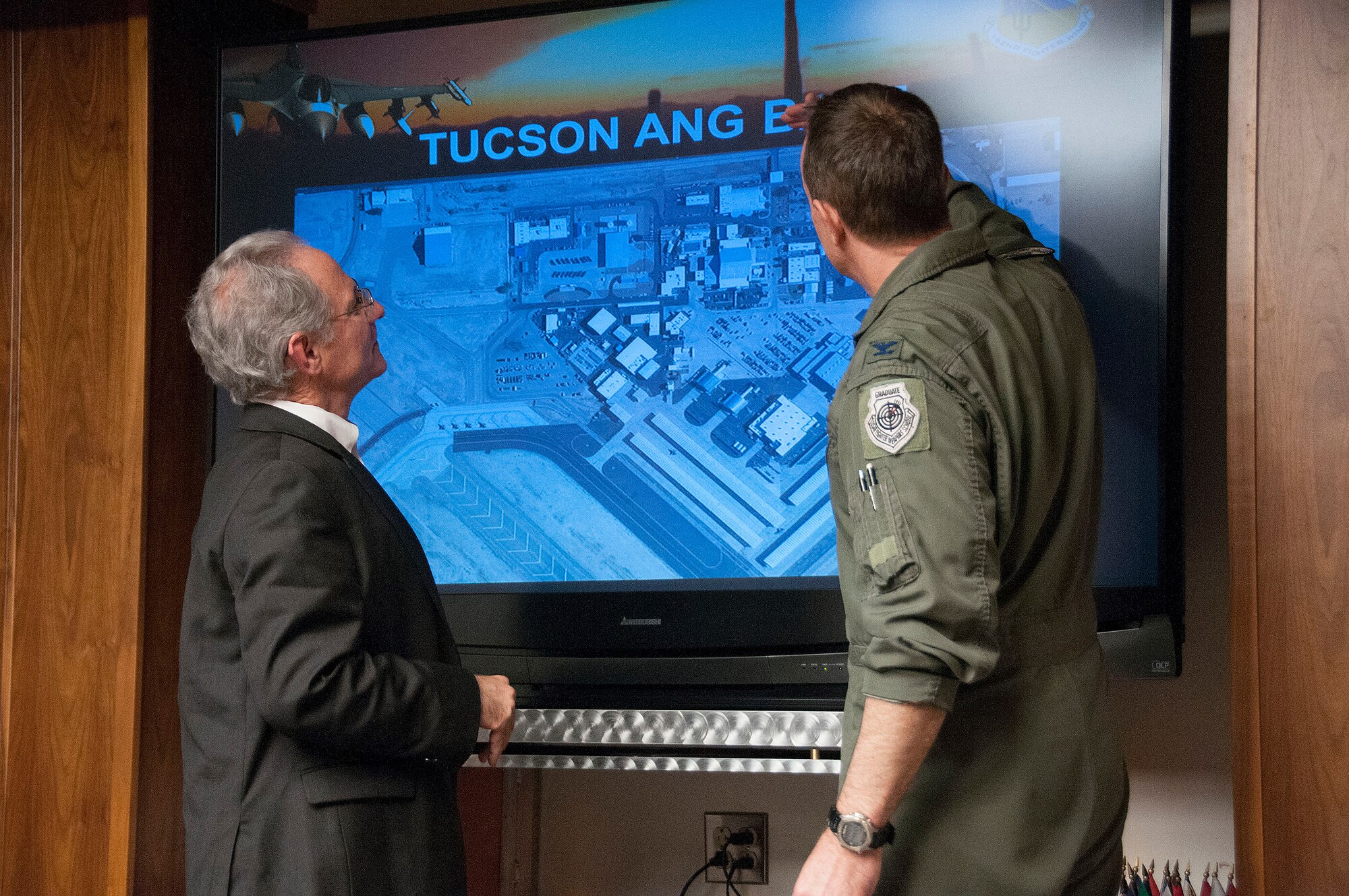Col. Phil Purcell, Commander of the 162nd Fighter Wing and Tucson Mayor Jonathan Rothschild take a closer look at wing infrastructure during a mission brief at the 162nd Fighter Wing Feb. 7. (U.S. Air National Guard photo by Master Sgt. Dave Neve/Released)