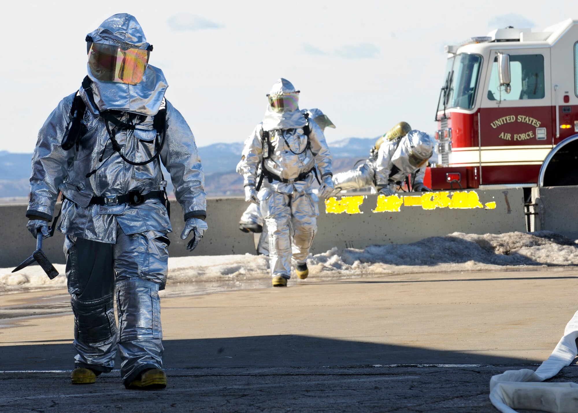 Firefighters from the 28th Civil Engineer Squadron scan the area for potential hazards while responding to a simulated attack during an operational readiness exercise at Ellsworth Air Force Base, S.D., Feb. 14, 2014. OREs are designed to prepare and train Airmen for any real world contingencies they may face. (U.S. Air Force photo by Senior Airman Anania Tekurio/Released)
