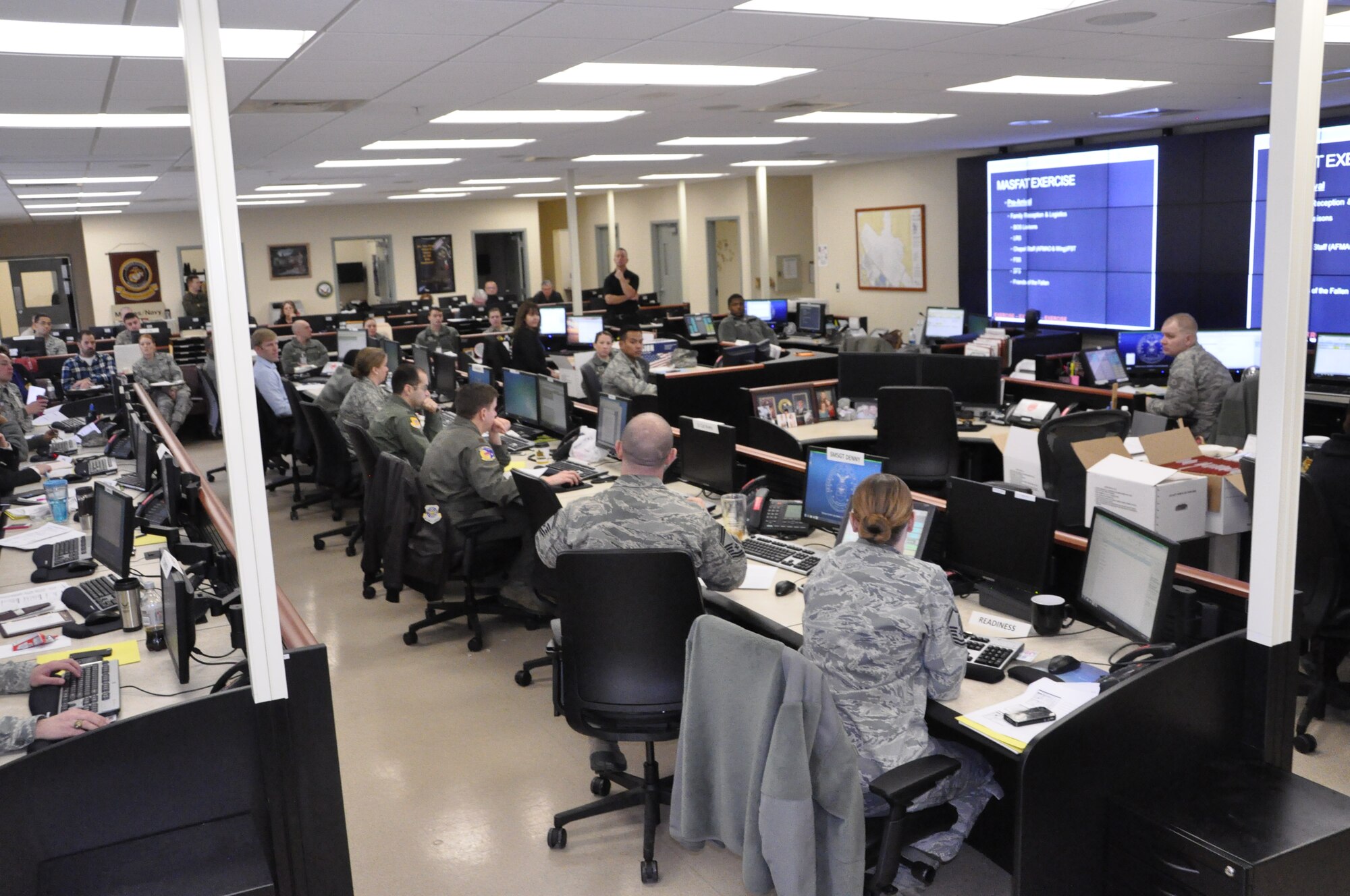 Personnel from Air Force Mortuary Affairs Operations, the 436th Airlift Wing and supporting agencies gather in the Command, Control and Communication Center at the Charles C. Carson Center for Mortuary Affairs, Dover Air Force Base, Del., for a mass fatality tabletop exercise Feb. 12, 2014. (U.S. Air Force photo/Staff Sgt. Chalanda Roberts) 