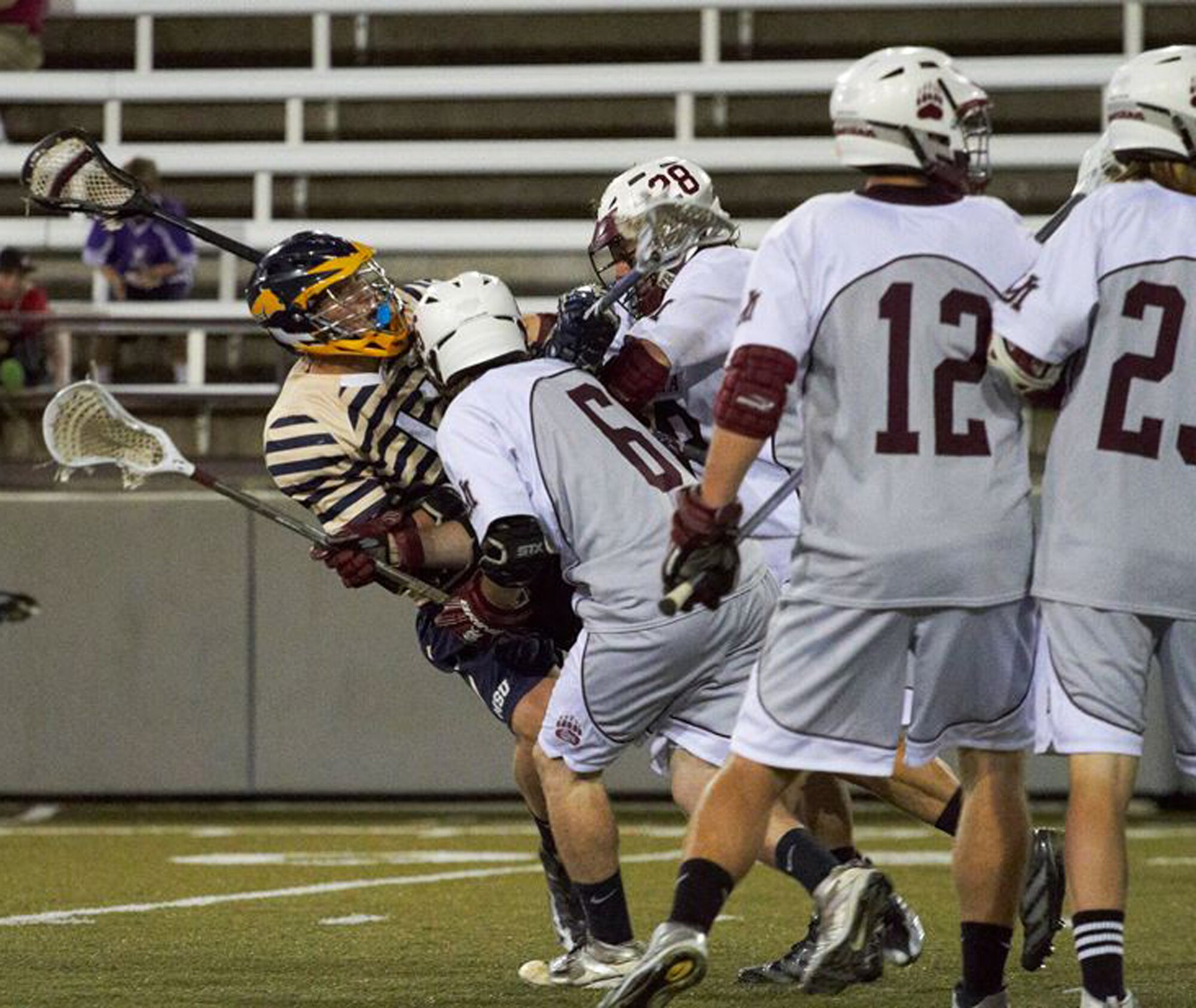 Members of the University of Great Falls Lacrosse Club block a defender from the opposing team during a game against their rivals, in the 2013 season. Great Falls currently has three lacrosse organizations, which are all preparing for the upcoming 2014 season. (Courtesy photo) 